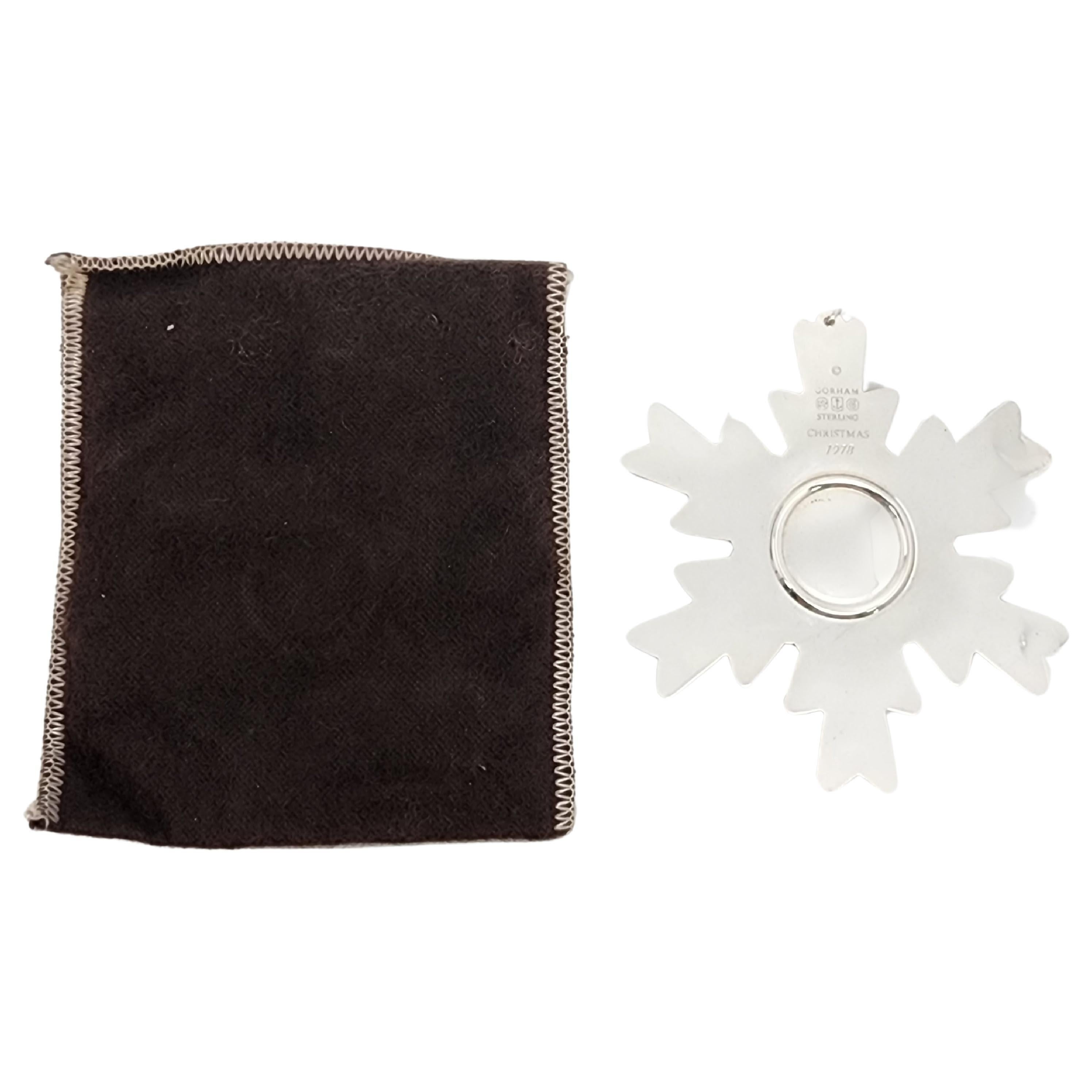 Gorham sterling silver snowflake ornament from 1978 with pouch.

Since 1970, Gorham has been celebrating the season with a yearly version of the classic snowflake form, creating a beautiful tradition of sparkling art. Includes original Gorham felt