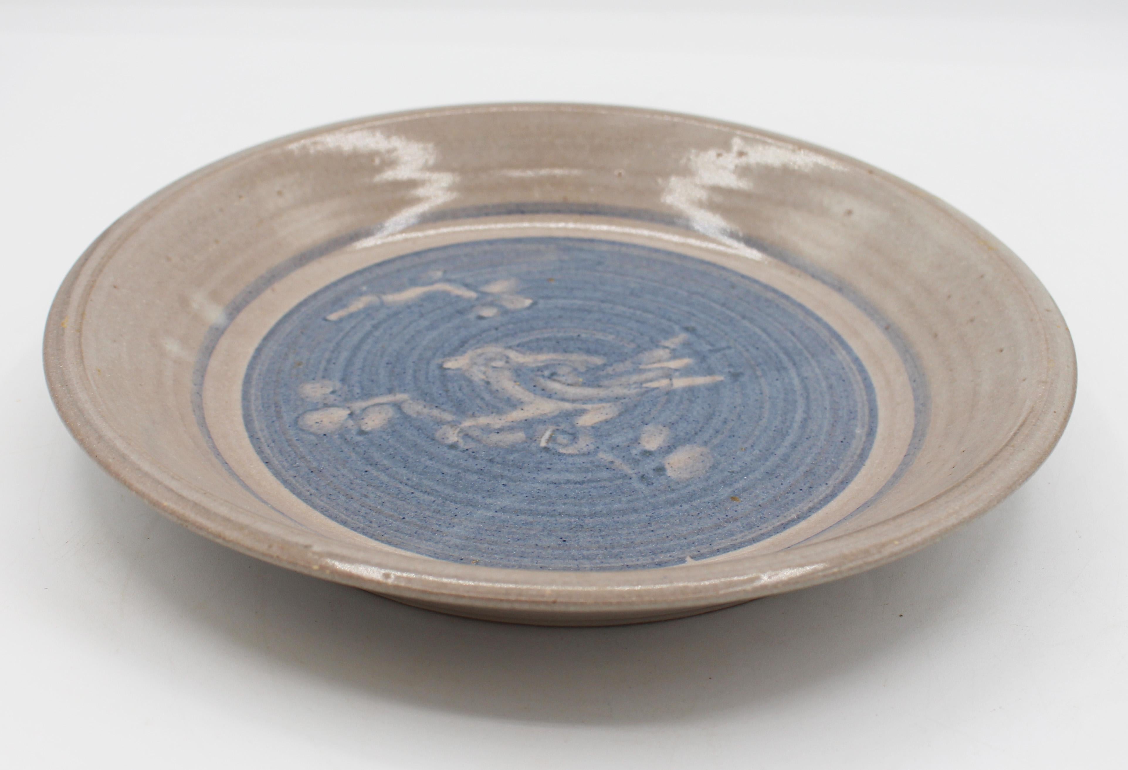 Jugtown Ware Pottery, 1978, Bird Motif Pie Plate. Decorated with a bird on a branch, butt to blue glaze. The mark created by Vernon Owens in 1972, cast from the first Jugtown stamp.
10.25