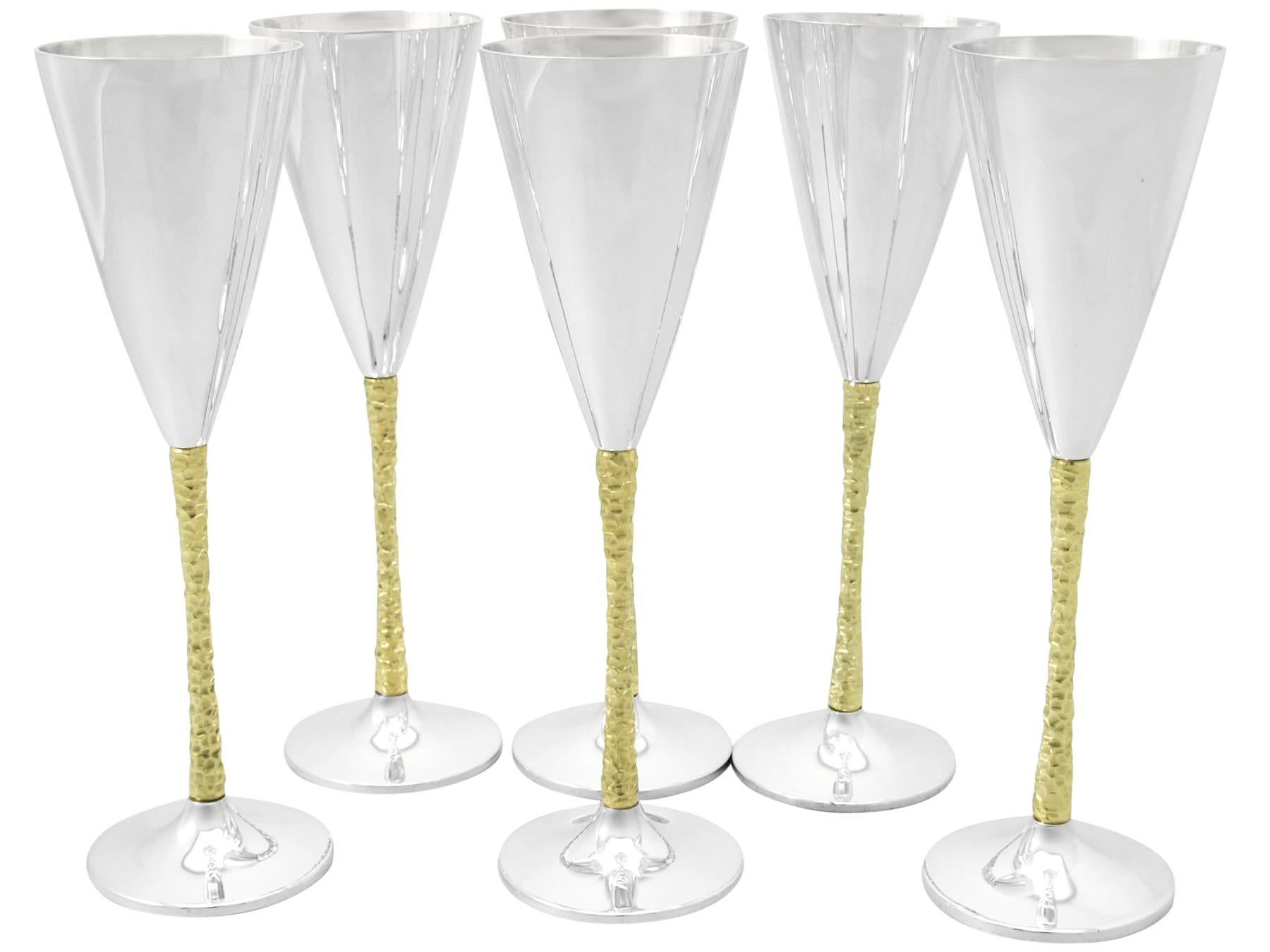 An fine and impressive set of six vintage Elizabeth II English sterling silver champagne flutes made by Stuart Devlin; an addition to our range of collectable silverware.

These impressive vintage Elizabeth II sterling silver champagne flutes have