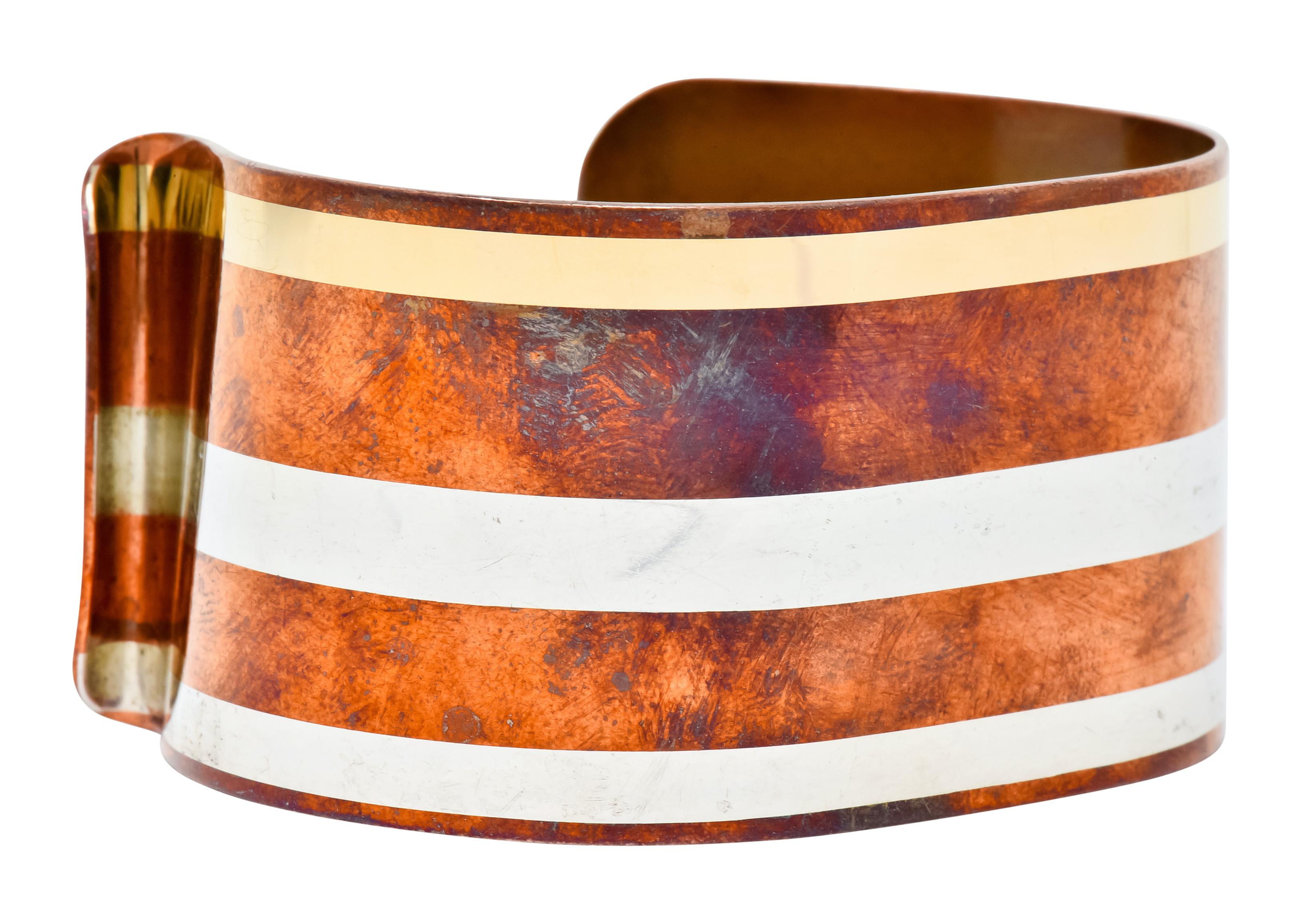 Open cuff style bracelet comprised of copper, brass, and silver featuring a beautifully aged finish

Inlaid with three polished sections

Terminating in unique curvature for a comfortable fit

Fully signed Tiffany & Co. 78 and is attributed to