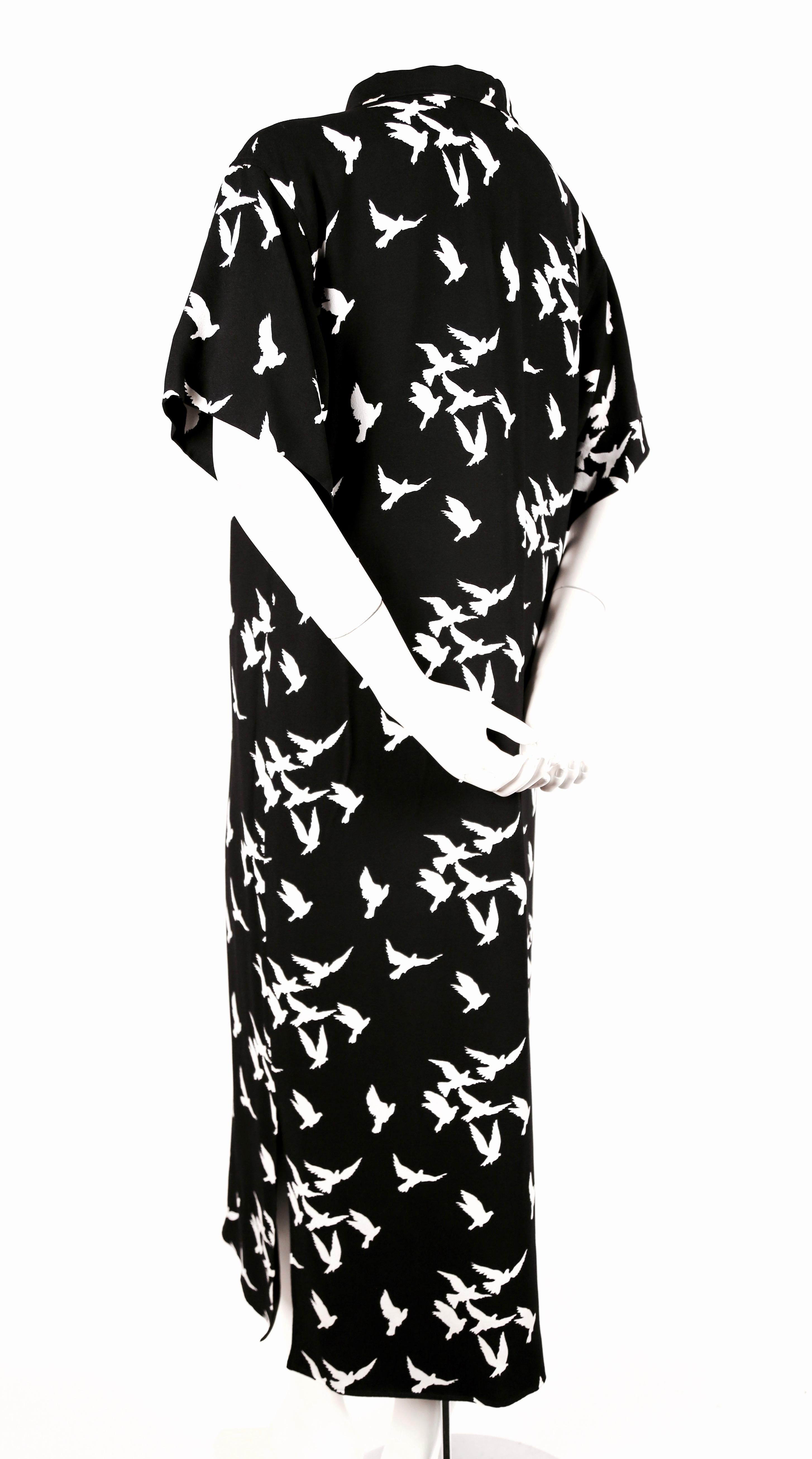 Jet-black crepe printed dress with white birds from Yves Saint Laurent dating to 1978. No size is indicated however this dress best fits a US 4 to slim 8. Approximate measurements: shoulder 18