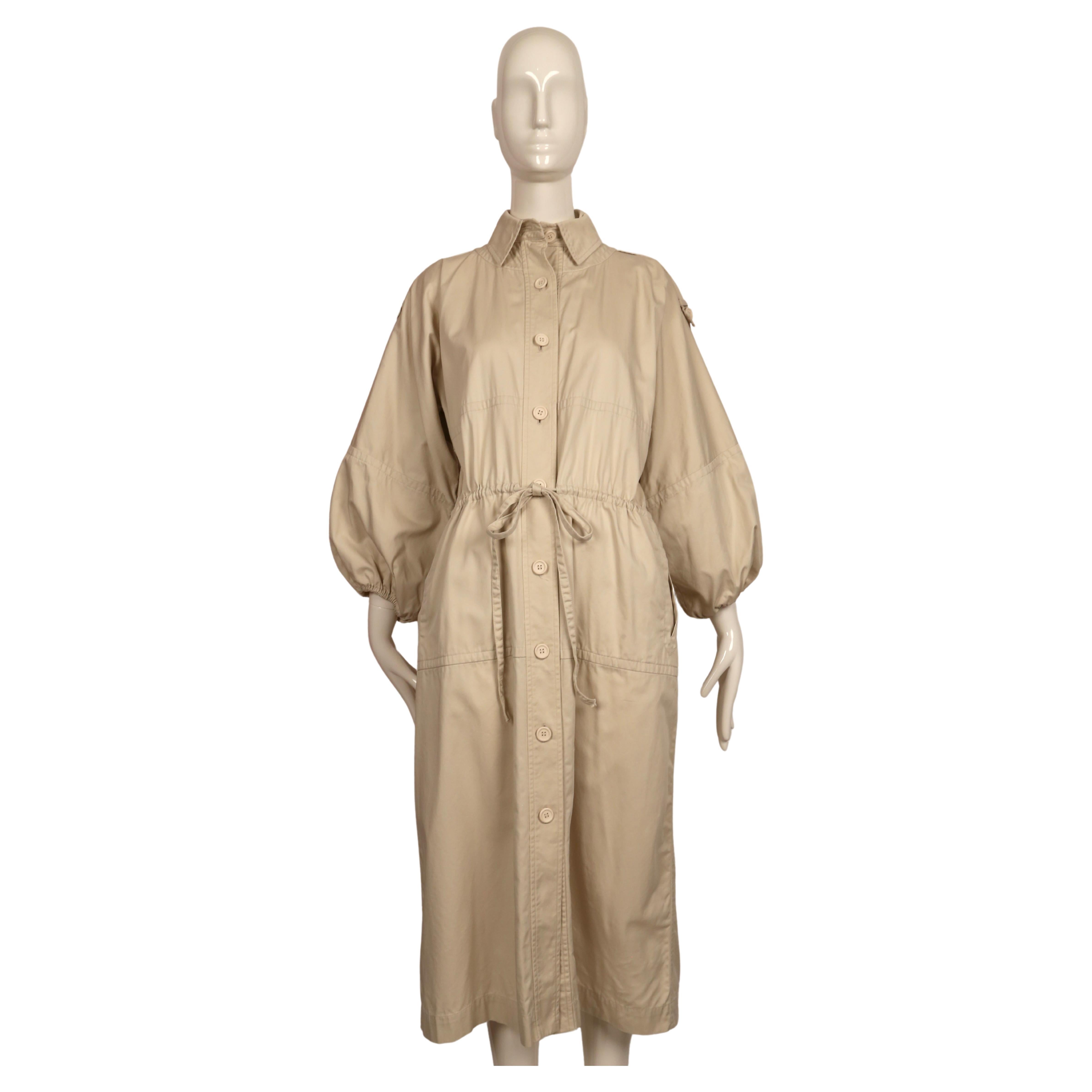 Very rare light tan cotton twill trench coat designed by Yves Saint Laurent as seen on the spring 1978 runway in several colors. This coat is labeled French 36 however this fits many sizes due to the loose cut. Sleeves have a slightly cropped fit.