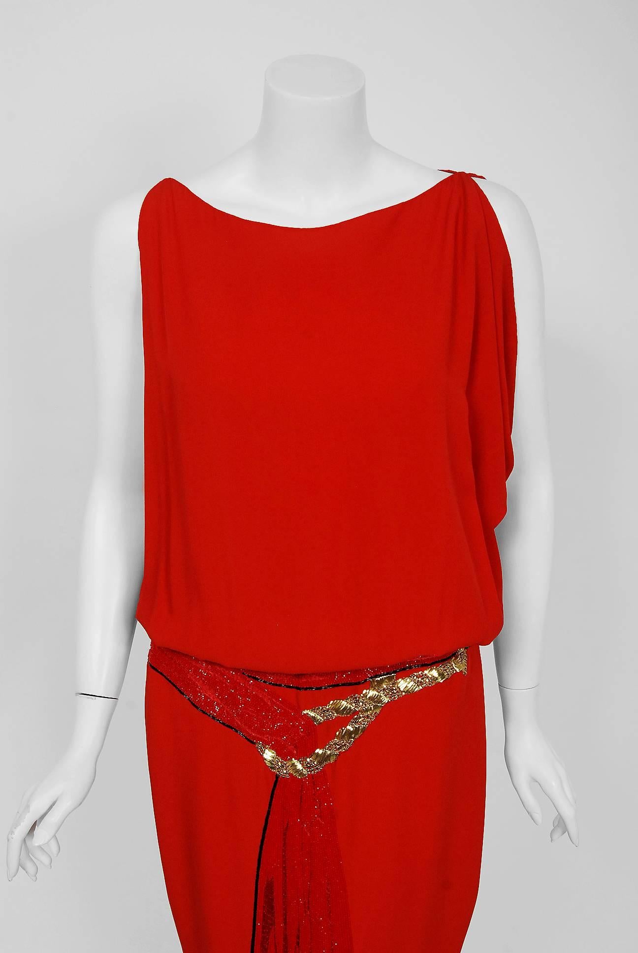 Gorgeous Bill Blass red silk-crepe beaded trompe l'oeil sash dress dating back to his 1979 collection. Building upon the innovations of European designers such as Coco Chanel, Blass made clothes that allowed women a modern sense of ease. He made