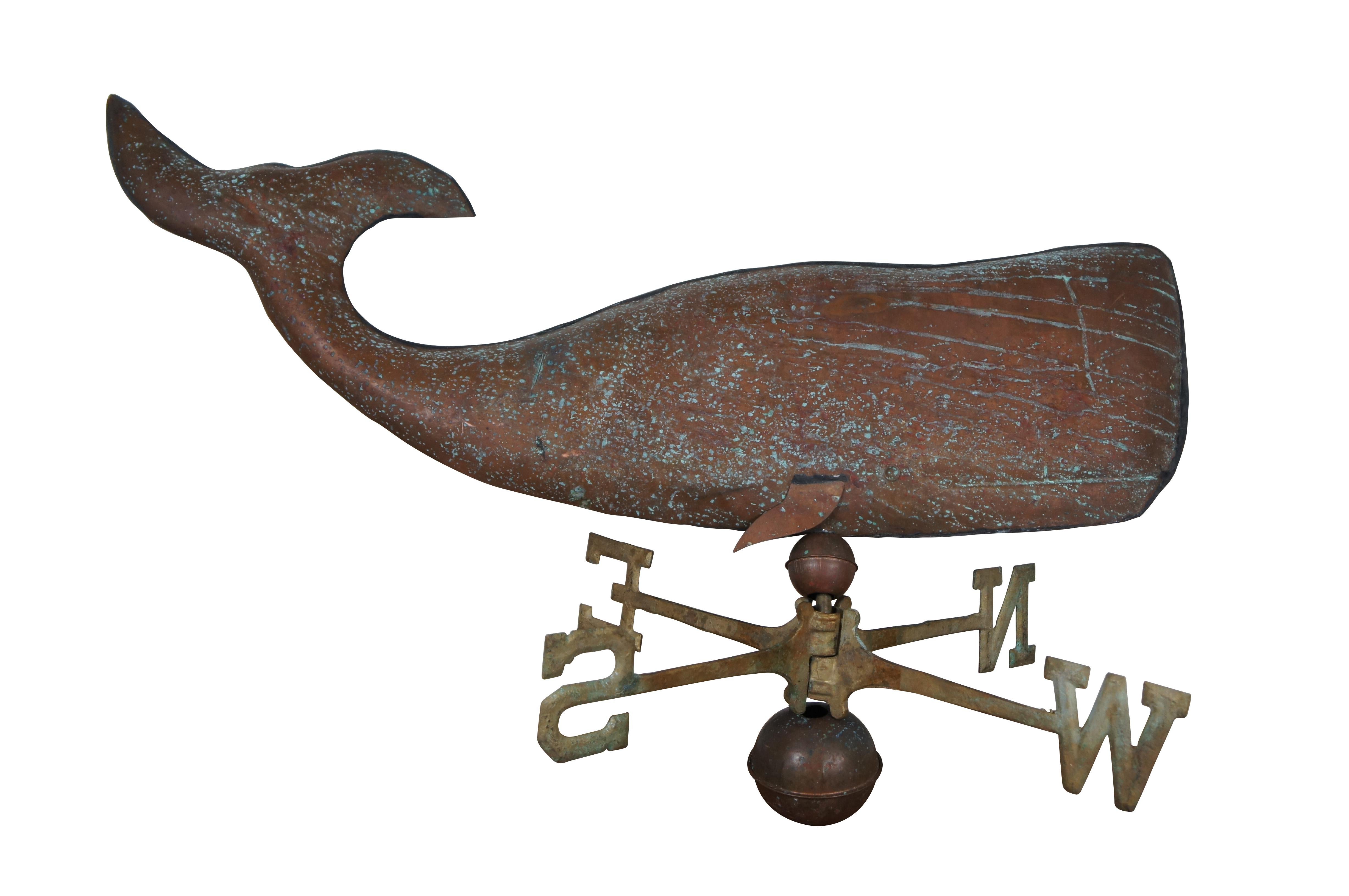 Vintage 1979 iron and copper wind / weather vane by Sign of the Crab. Features traditional cardinal directions in gilded iron, framed by a pair of graduated copper balls and topped with a hollow copper sperm whale. Includes instructions and brass