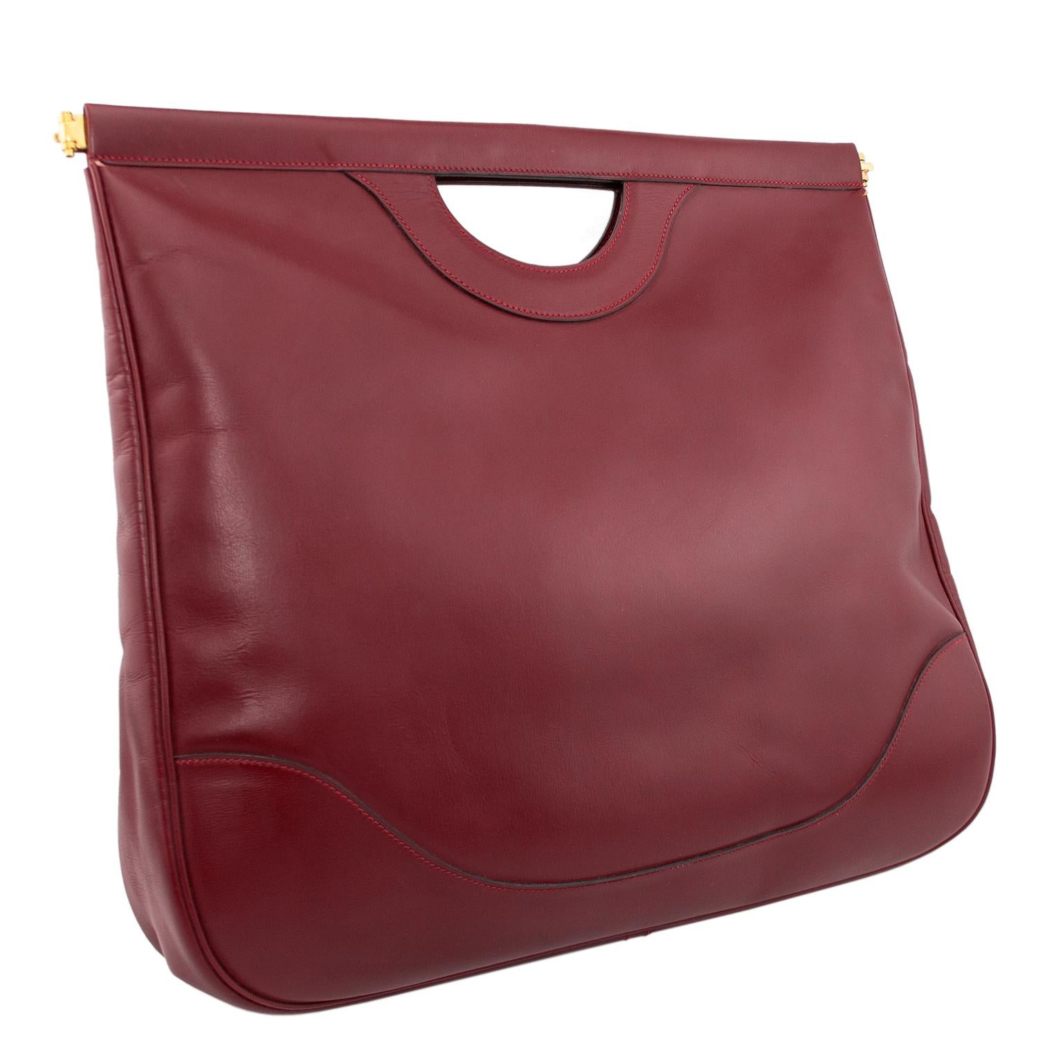 Late 1970's-early 1980's Hermes oversize foldable cut out handle shopper in burgundy box leather. Not often seen and this one is in perfect condition. Spring set metal opening allows great access. Very unique piece, can be worn 2 ways folded down as