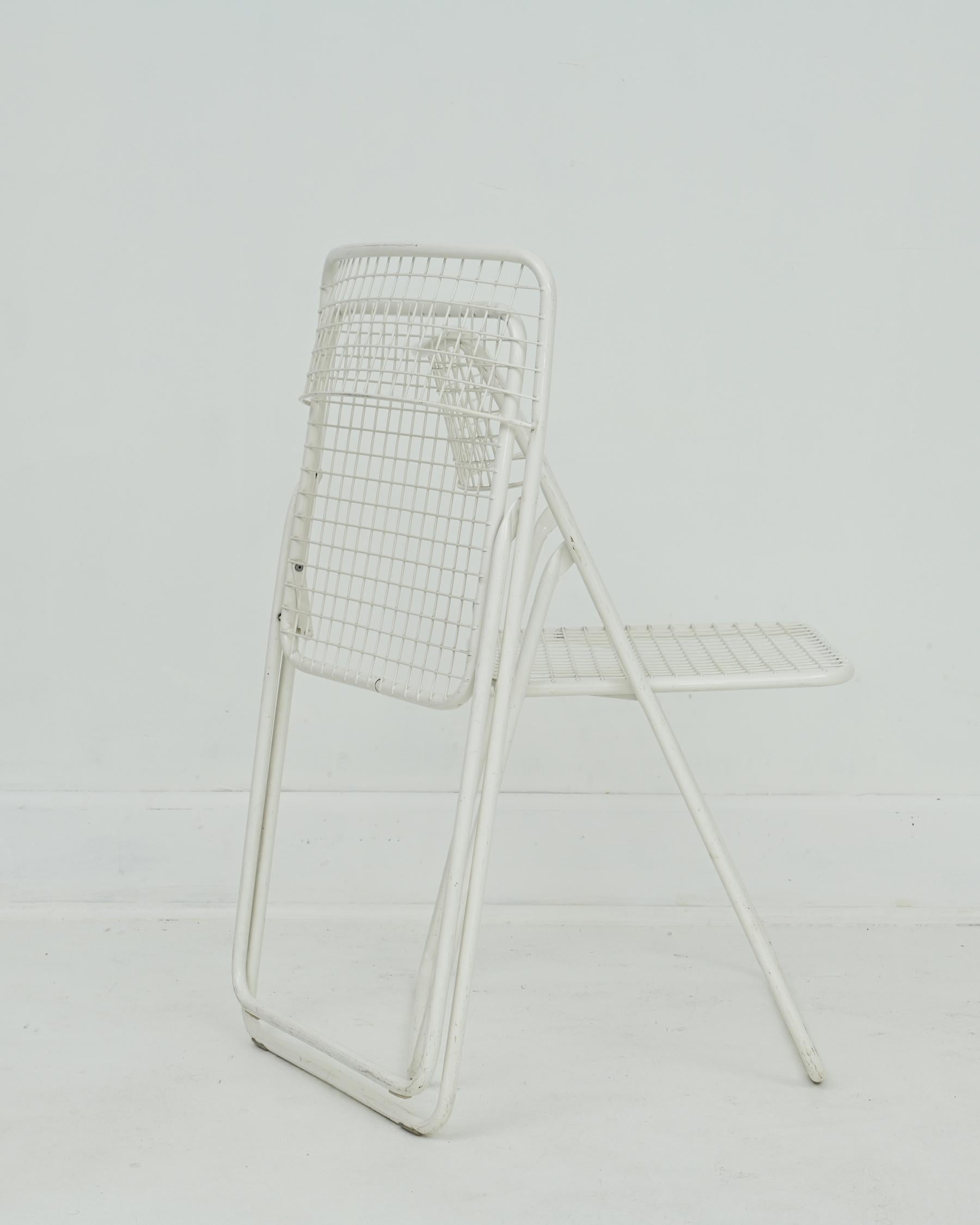 1979 white metal folding grid chairs designed by Niels Gammelgaard. Excellent condition, very nice color to go with anything. Minor scuffs from age and use. Four are available and sold in pairs. 
