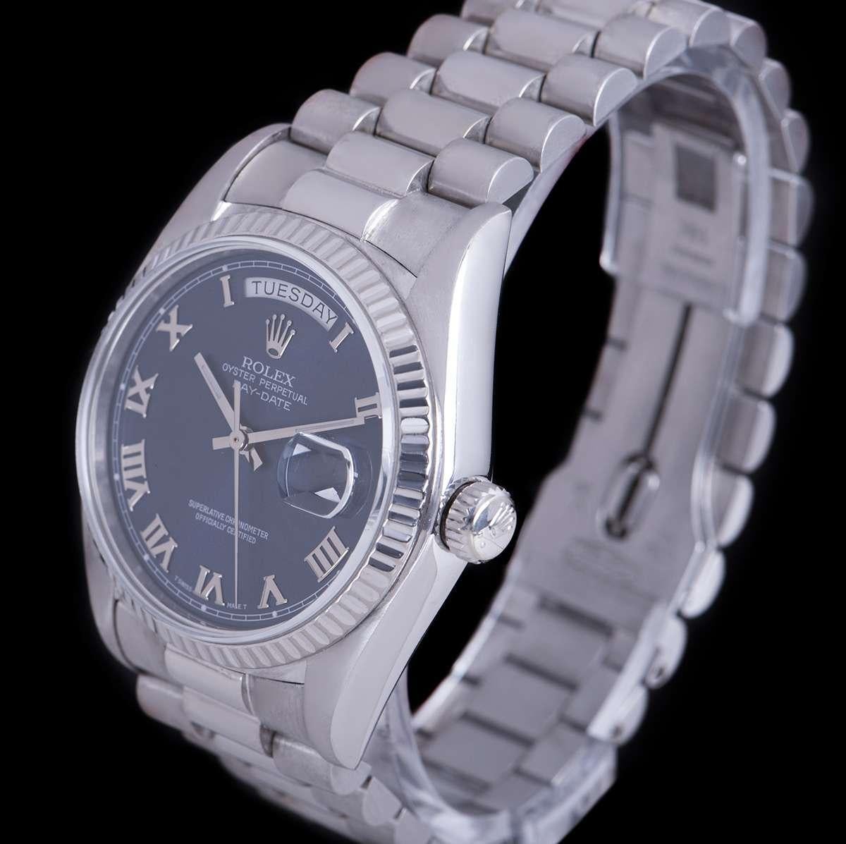 An 18k White Gold Oyster Perpetual Day-Date Gents Wristwatch from 1979, blue dial with applied roman numerals, day aperture at 12 0'clock, date aperture at 3 0'clock, a fixed 18k white gold fluted bezel, an 18k white gold president bracelet with a