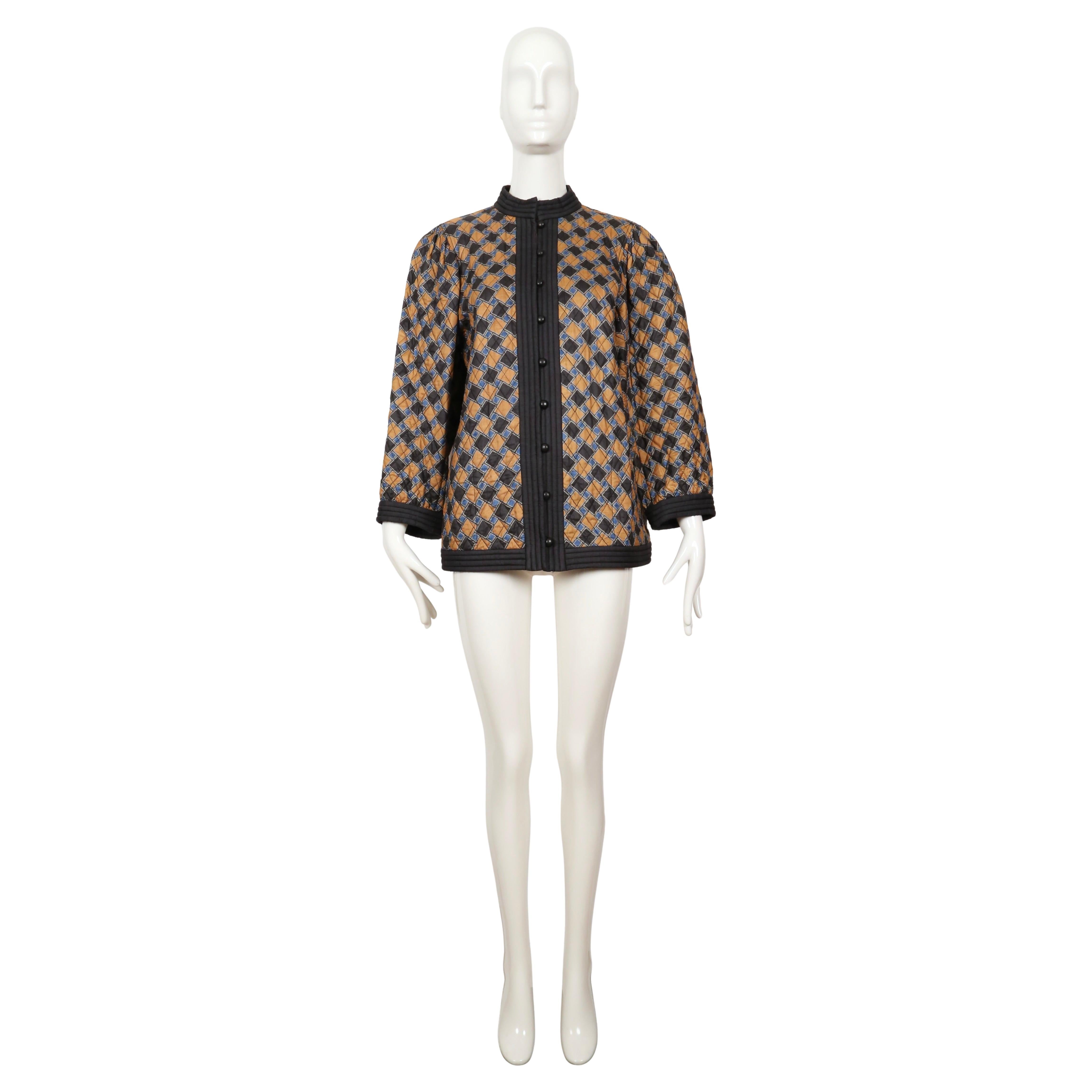 Very rare, abstract print, silk quilted jacket designed by Yves Saint Laurent dating to 1979. Jacket is labeled a FR 36 but can also fit a French 38 (US 2-6) due to the oversized cut. Colors are blue and a muted orange with deep navy blue trim and