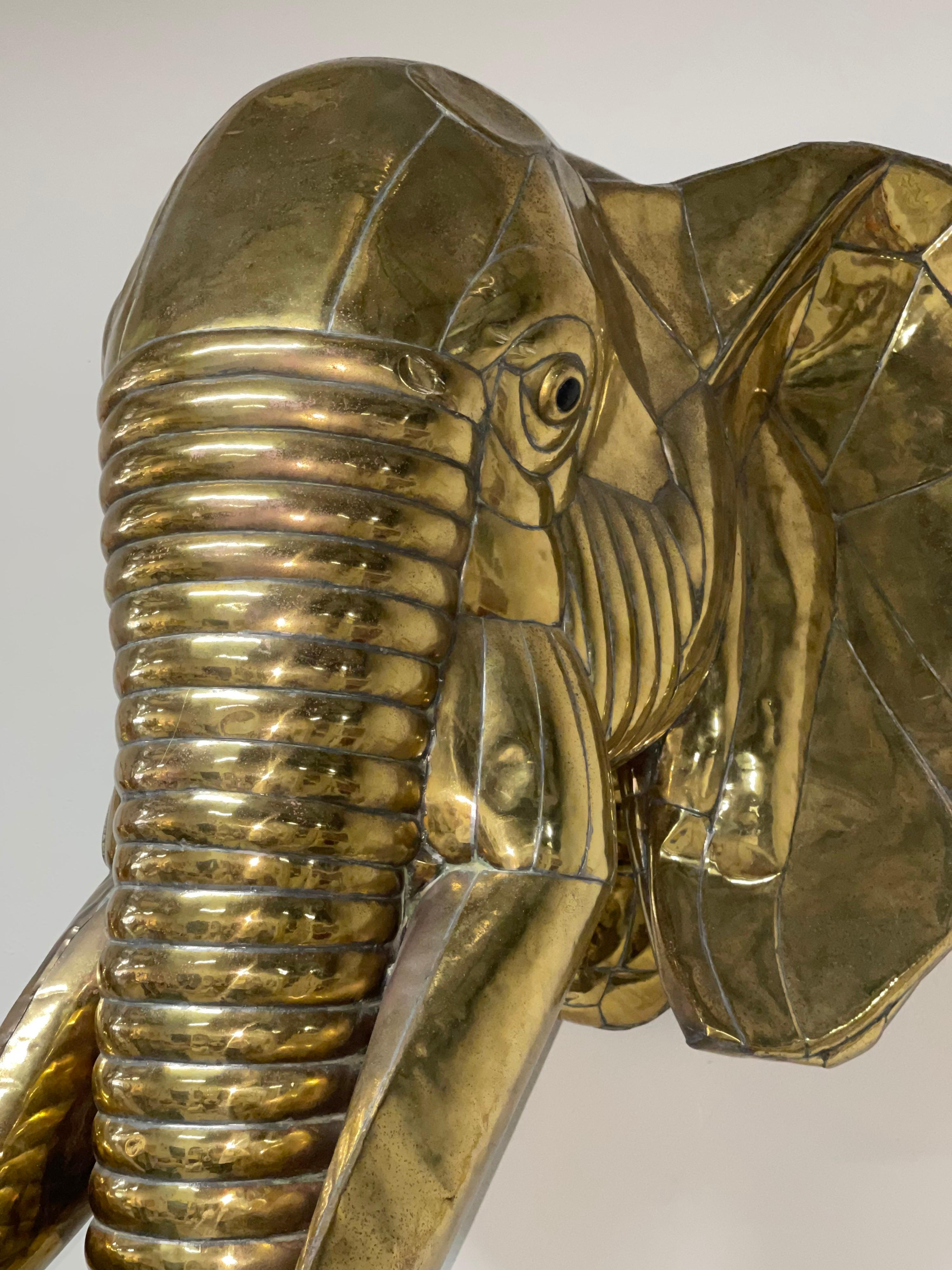 An incredible life size Elephant sculpture by Sergio Bustamante in Brass. Accompanied by a copy of a certificate of authenticity from the retailer who sold the piece in 1979. The certificate says it is signed, but I haven't seen the signature it's a