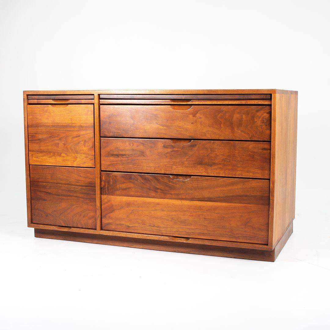 This is a large handmade credenza filing cabinet, produced by Arden Riddle in Copley, Ohio in 1979. The piece was crafted by hand of polished walnut that has been oiled. It has two pull-out writing surfaces, three large drawers with custom dividers
