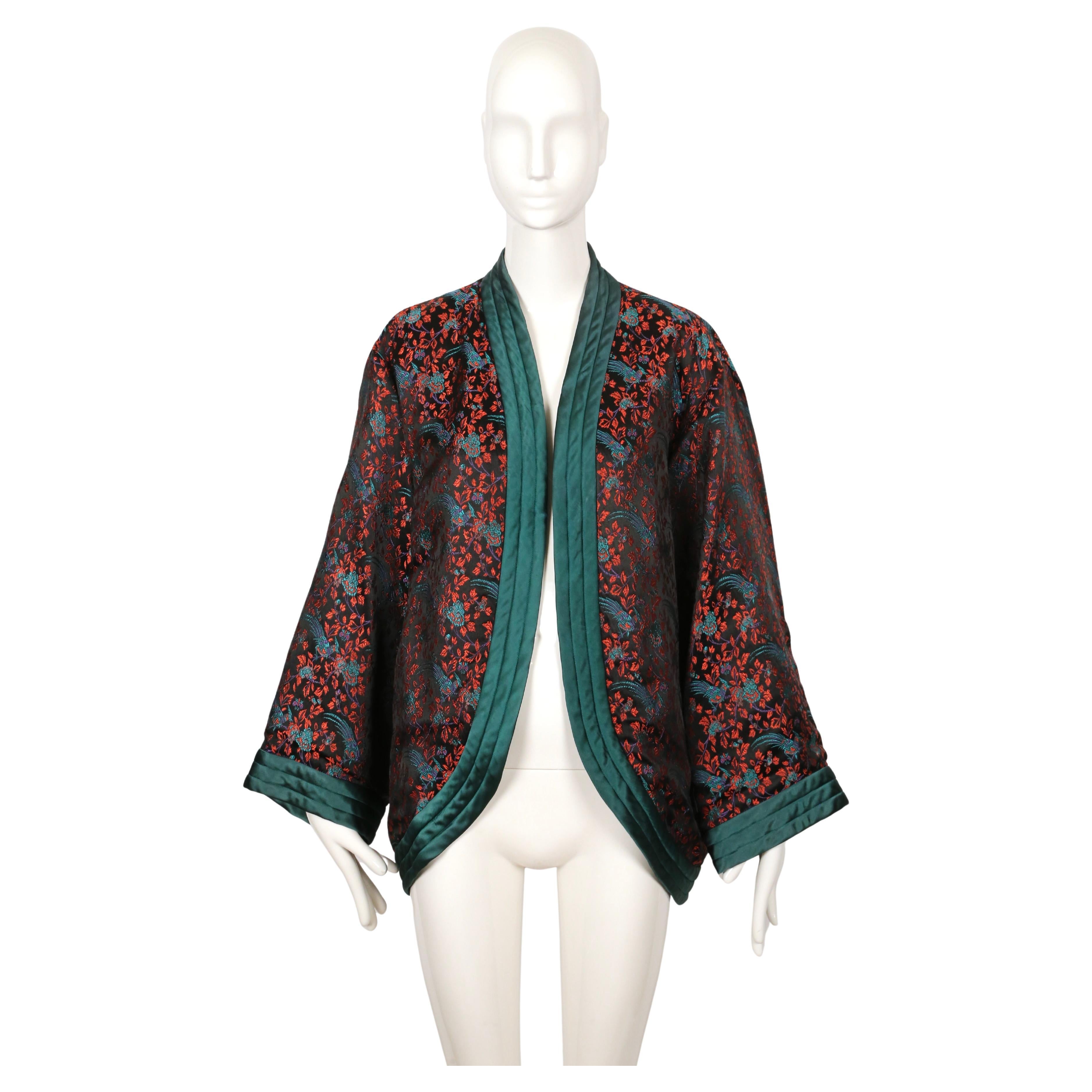 Satin kimono jacket with beautiful Asian pheasant motif designed by Yves Saint Laurent dating to 1979 as seen in an alternate color-way on the runway. No size indicated however this can fit a variety of sizes due to the loose cut. Jacket was not
