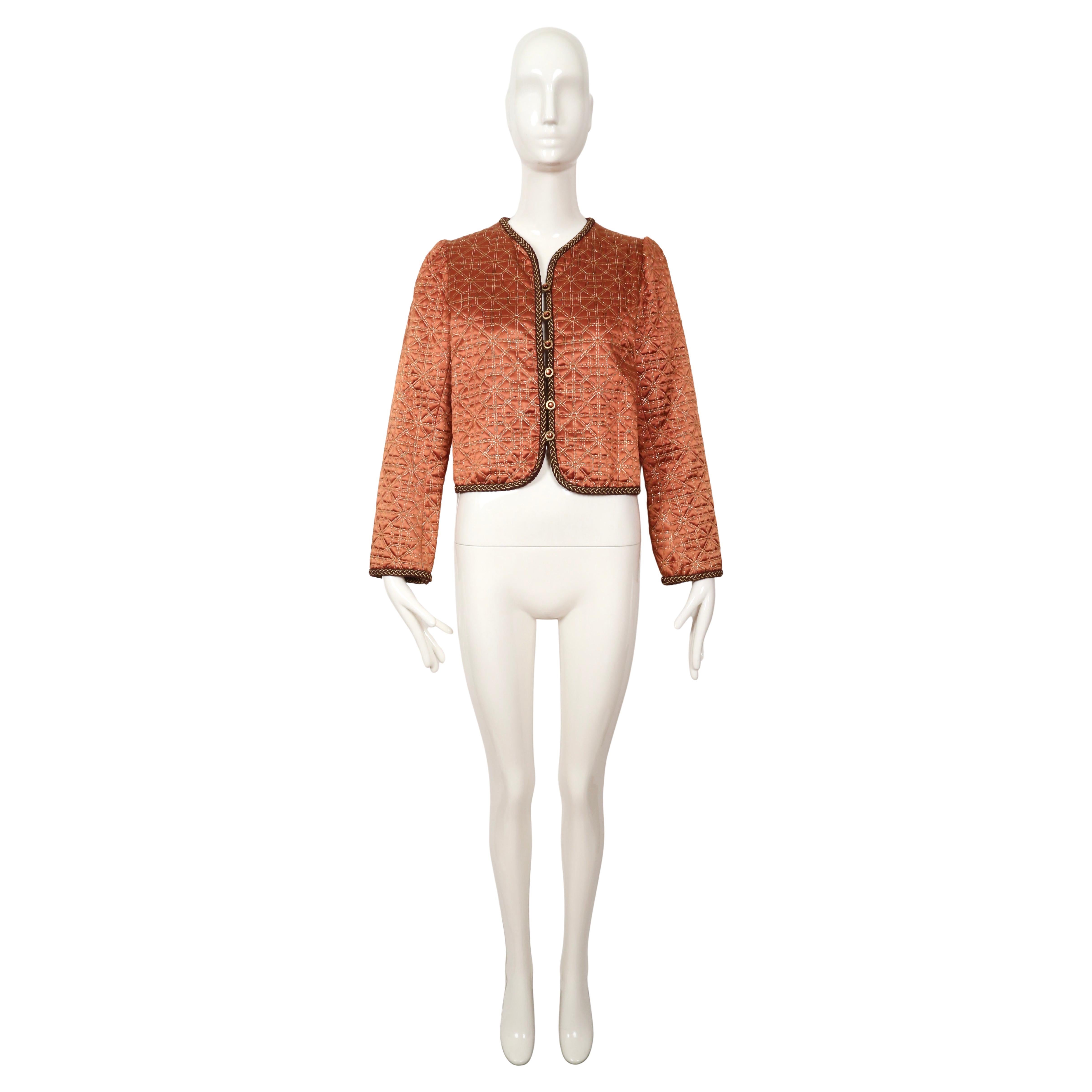 Copper, satin Matelasse quilted jacket with decorative metallic gold trim and glass buttons designed by Yves Saint Laurent dating to 1979 as seen on the fall runway.  This is a great transitional piece that can be worn in the spring as well. This