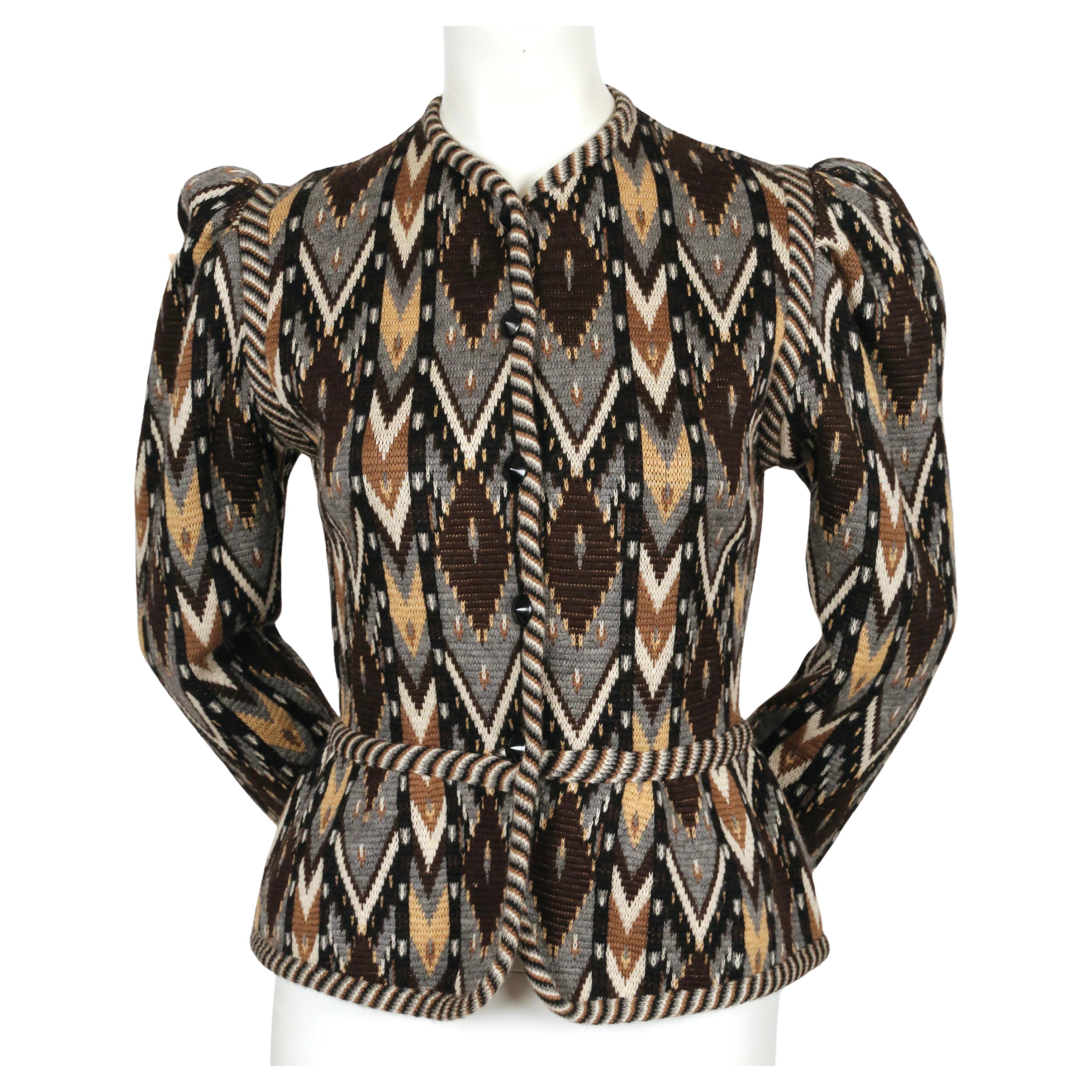 Multi-colored, Ikat patterned, woven wool cardigan with puff sleeves and peplum hem detail designed by Yves Saint Laurent dating to fall of 1979. Rare brown, grey, tan, off-white and black colorway. Labeled a French size 38. Approximate measurements