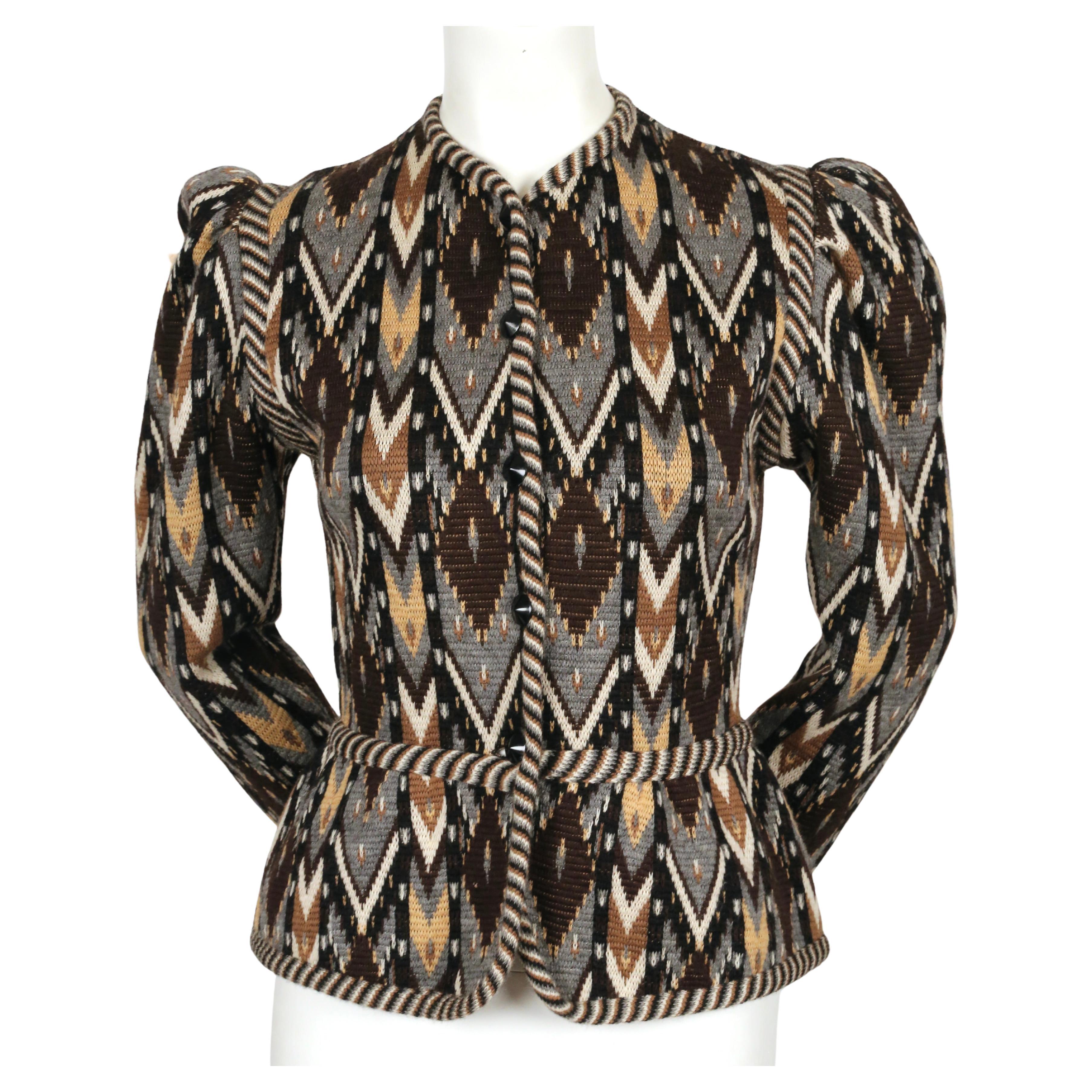Multi-colored, Ikat patterned, woven wool cardigan with puff sleeves and peplum hem detail designed by Yves Saint Laurent dating to fall of 1980 as seen on the runway. Rare brown, grey, tan, off-white and black color-way. Labeled a French size 38.