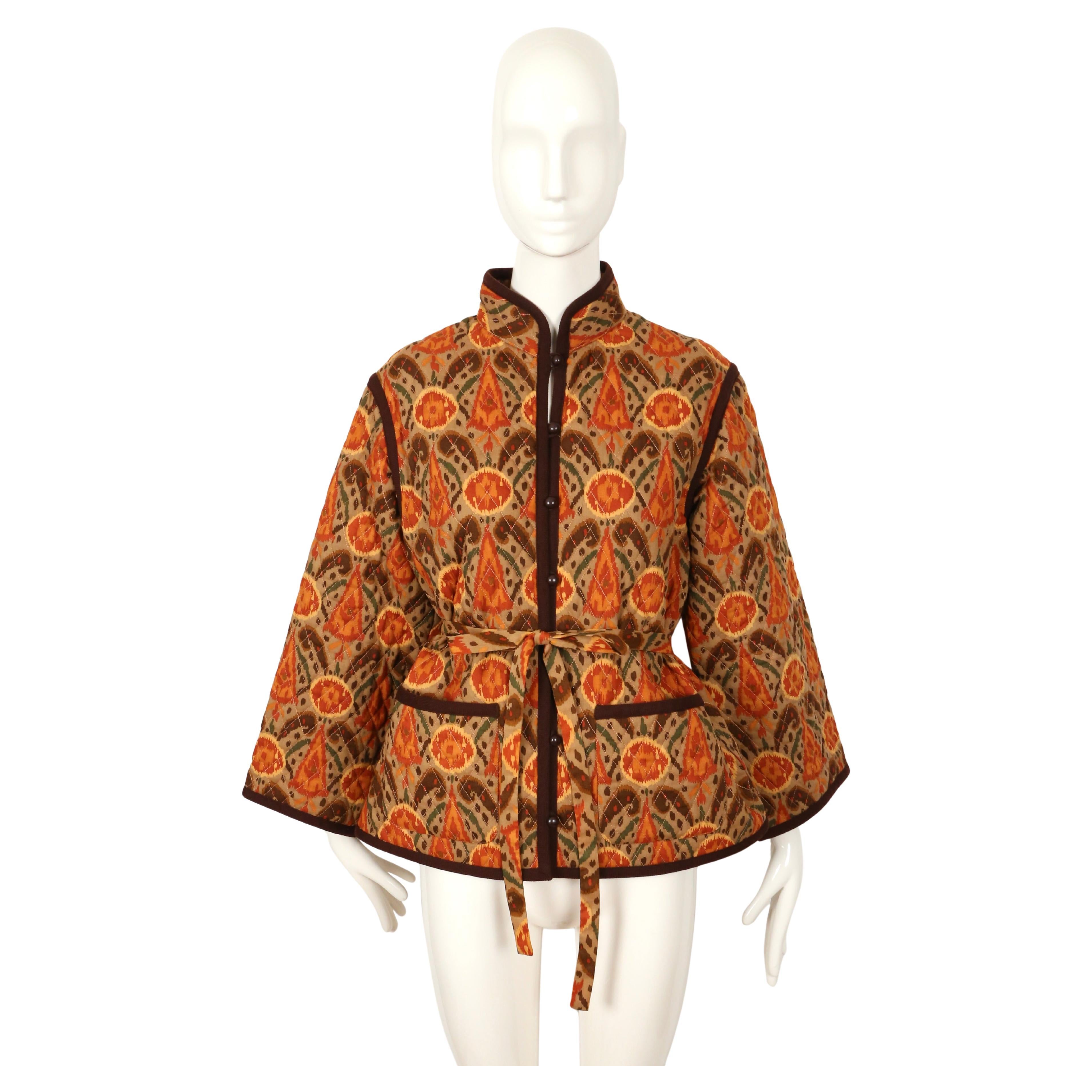 Very rare and striking, wool quilted Ikat peasant jacket with brown woven trim, button closure and optional waist tie from Yves Saint Laurent dating to 1979 as seen on the fall runway. French size 38. Approximate measurements: shoulder 16