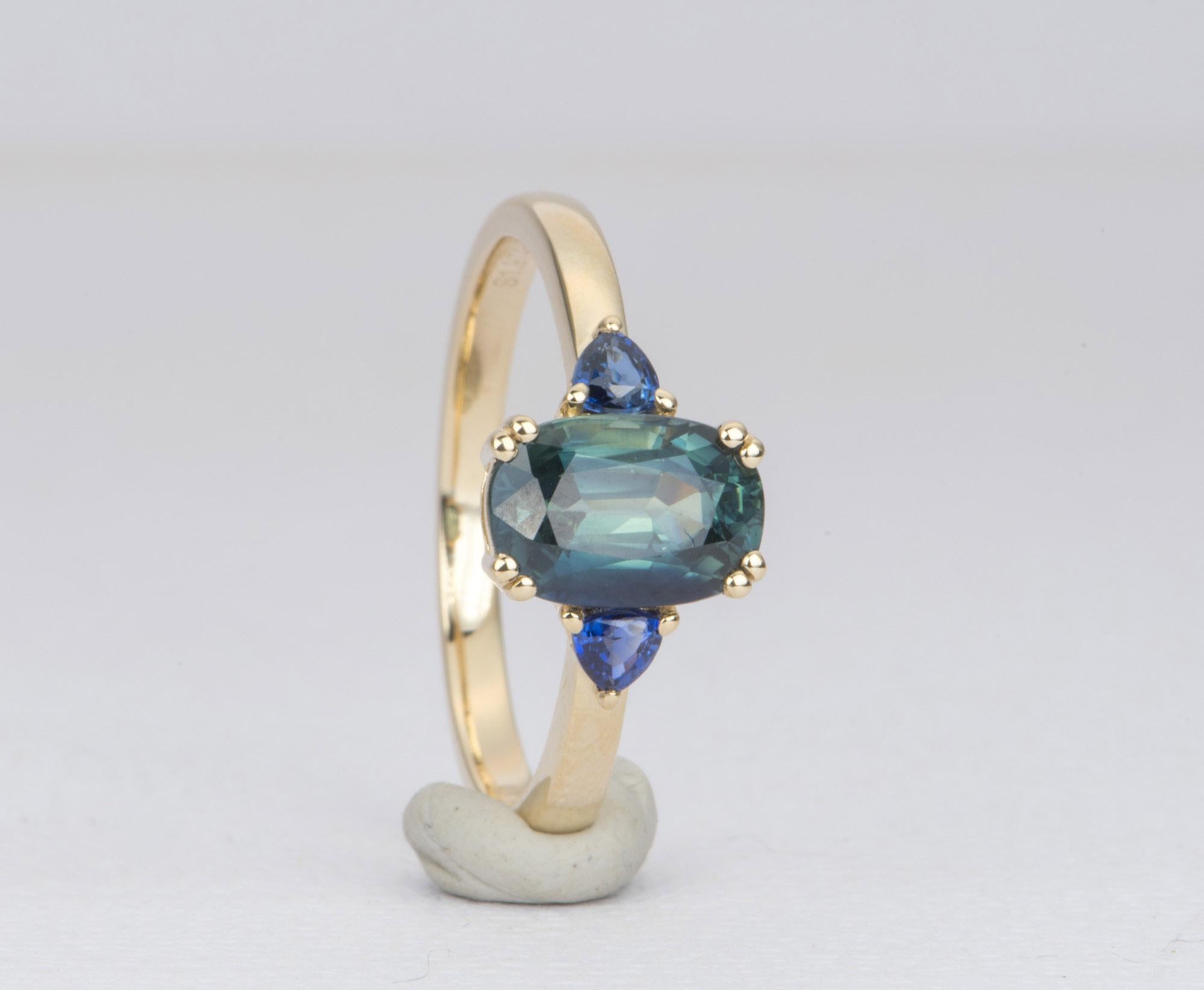 oval teal sapphire engagement ring