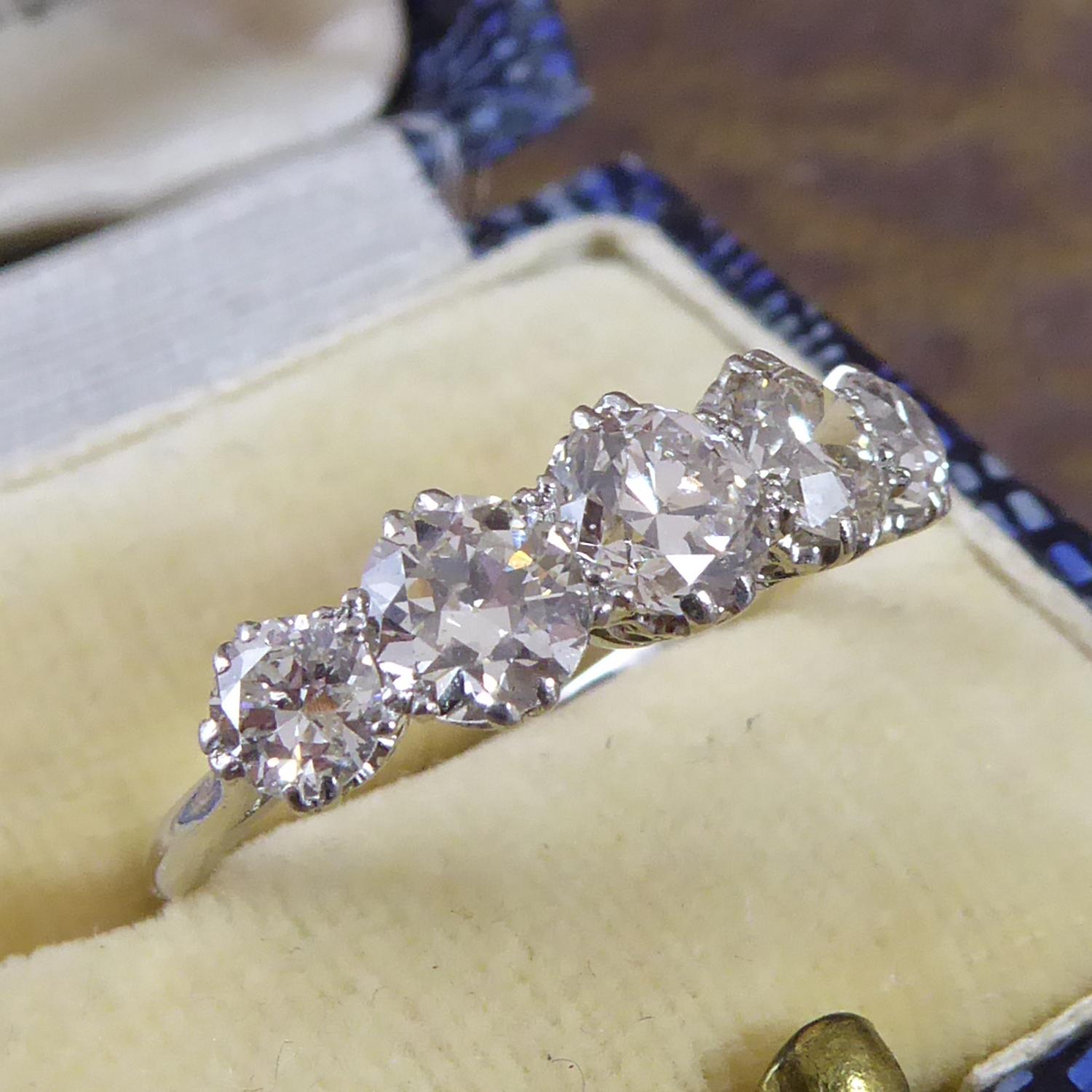 A vintage diamond five stone ring featuring early brilliant cut diamonds graduating in size from the centre diamond.  The diamond sizes, carat weight and grading (all approximate) are as follows:

1 x 0.56ct, 5.10mm x 5.10mm x 3.31mm (centre stone)