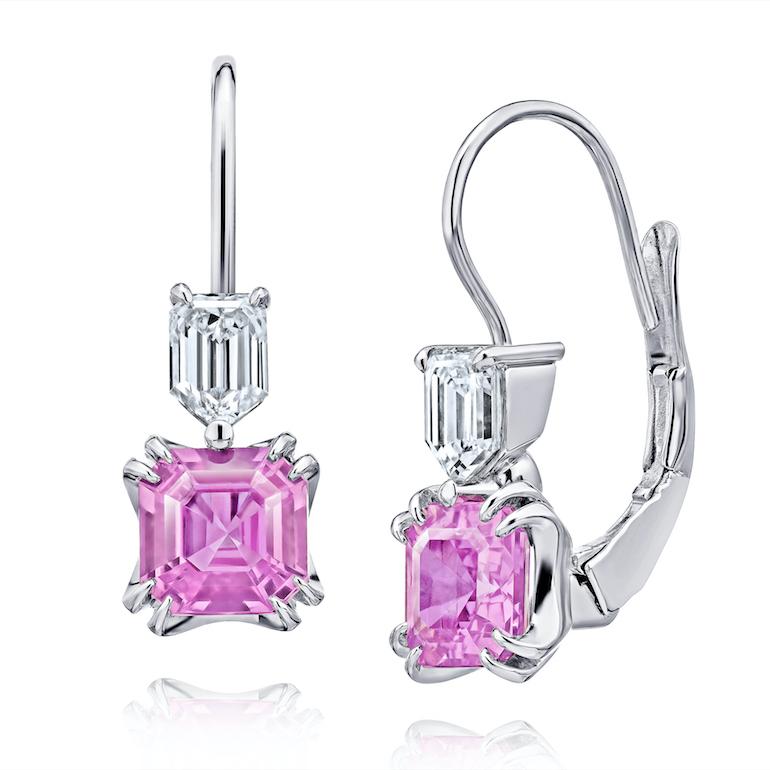 Two emerald cut (natural no heat) pink sapphires weighing 1.98 carats set with two step bullet diamonds weighing .60 carats set in platinum lever back earrings.
