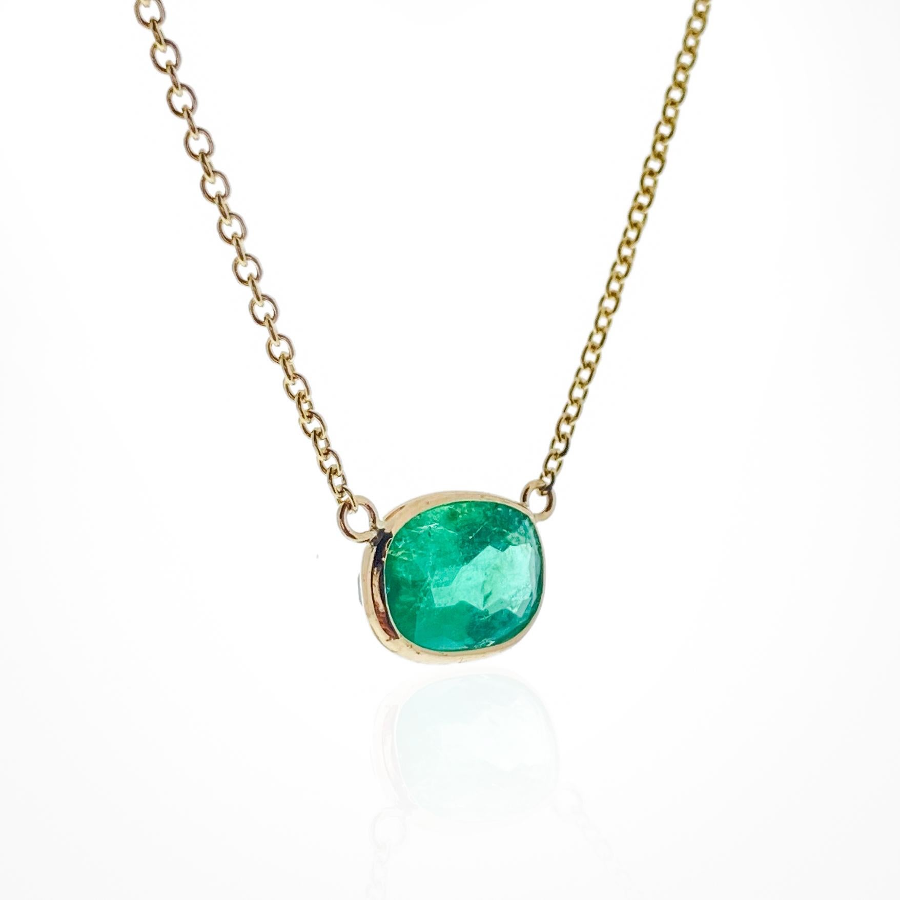 This necklace features an oval-cut green emerald with a weight of 1.98 carats, set in 14k yellow gold (YG). Emeralds are well-known for their rich green color, and the oval cut is a classic and elegant choice for gemstones, offering a timeless and