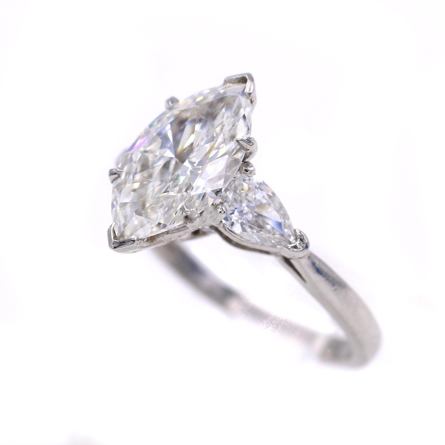 Beautiful, lively and brilliant 1.98 carat marquis cut diamonds, set in a handcrafted platinum mounting embellished by 2 perfectly matched bright white pear shape diamonds. Weighing only 2 points less than 2 carats the diamond looks larger than most