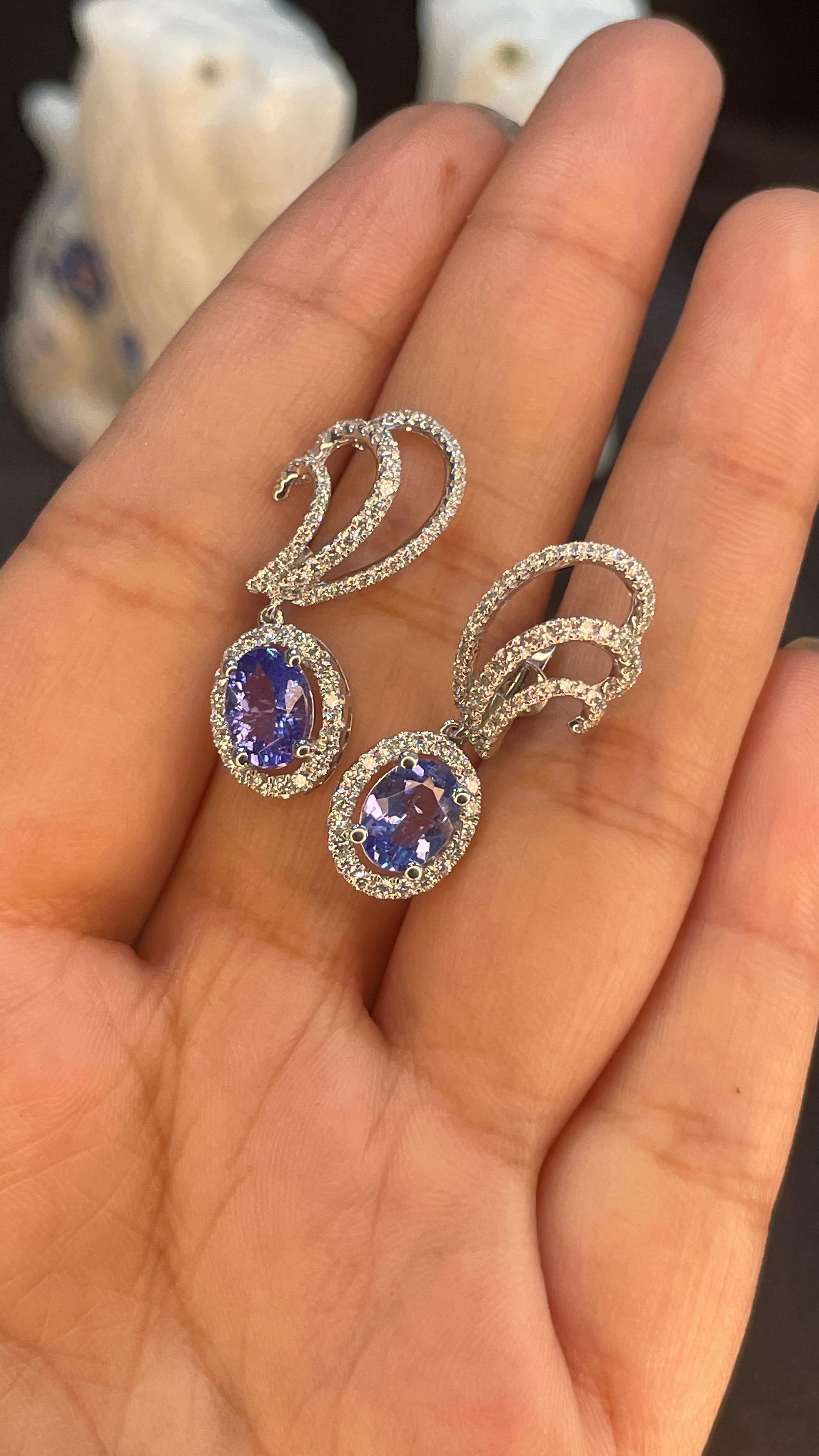 Earrings create a subtle beauty while showcasing the colors of the natural precious gemstones and illuminating diamonds making a statement.

Oval cut tanzanite earrings in 14K gold. Embrace your look with these stunning pair of earrings suitable for