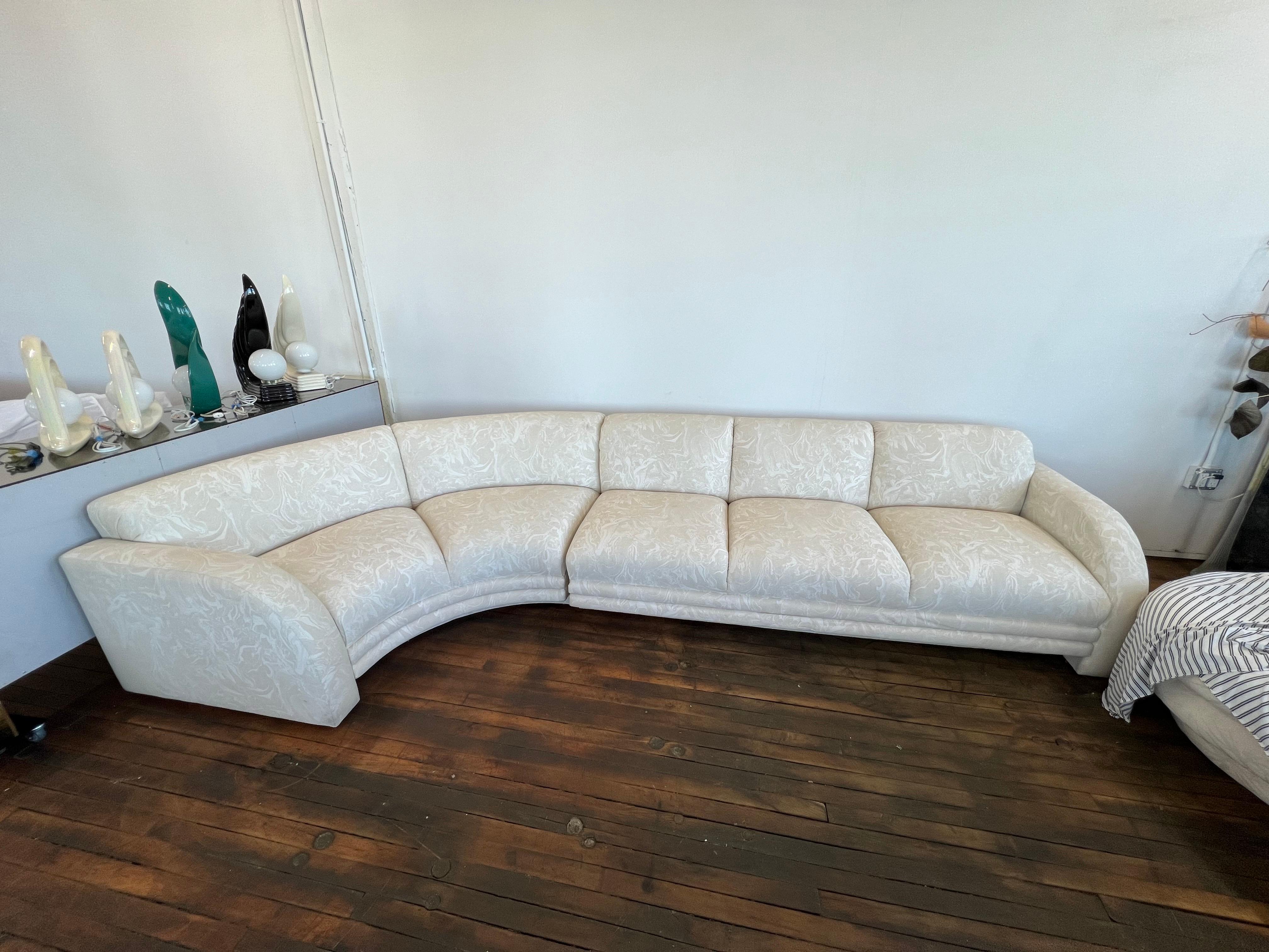 2 pieces curvy L-shaped white sectional. They were made with a swirl pattern, custom made in 1980.

It can sit 5-6 people comfortably.