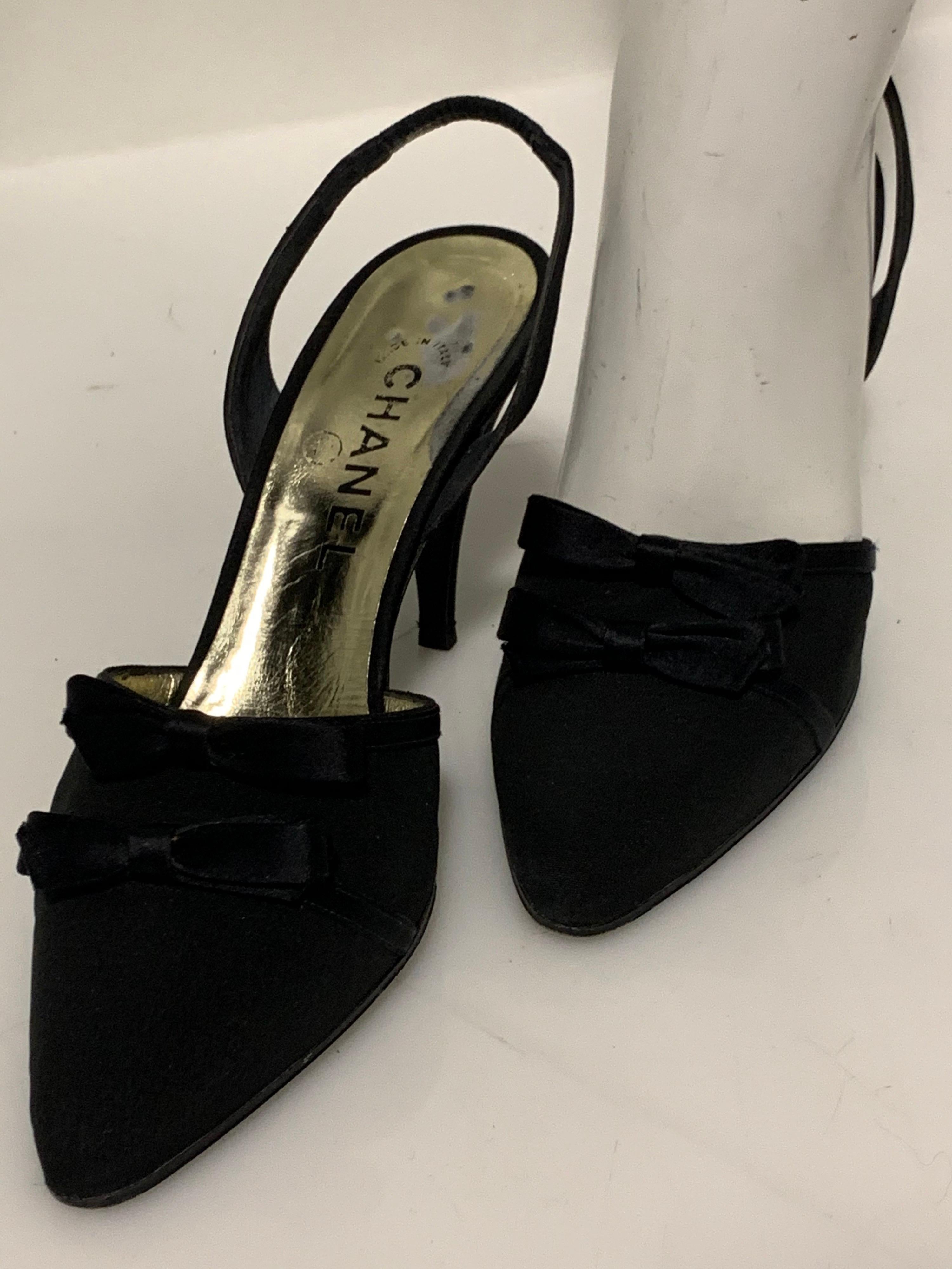 1980s Chanel classic black peau de soie silk slingback stiletto shoe with straight, high vamp and double bow detail. Size 7M. 