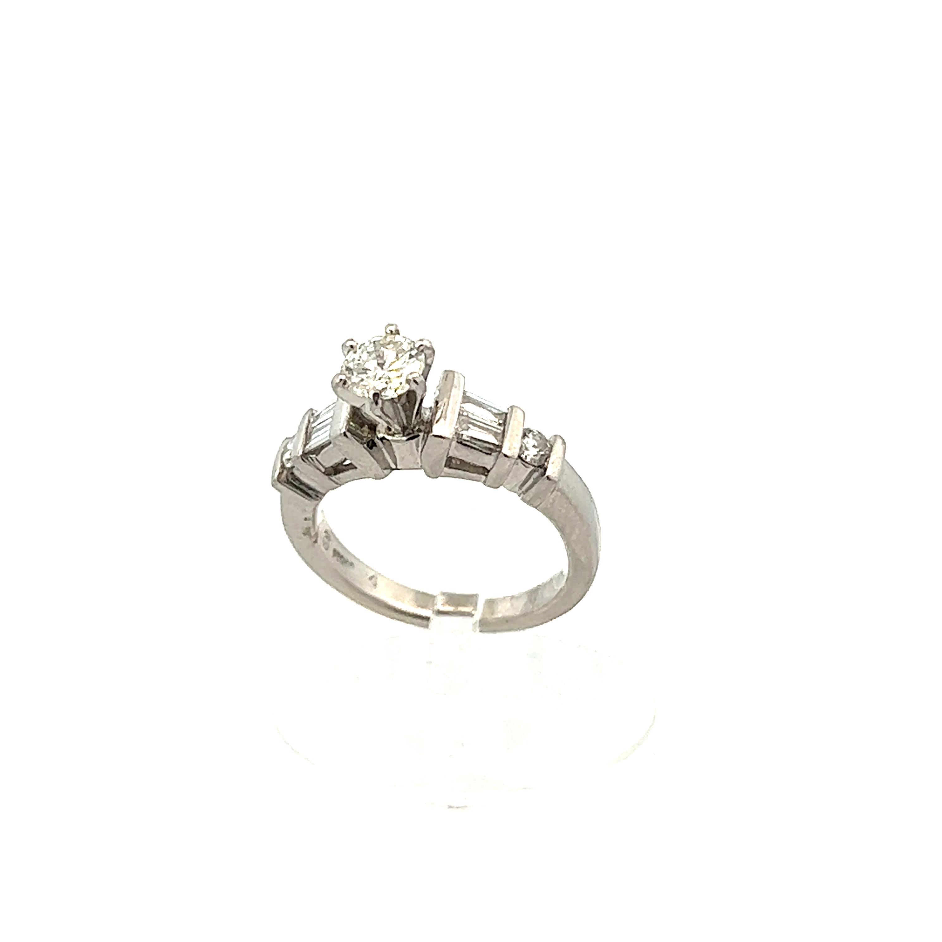
This 1980s contemporary platinum ring with round and baguette cut diamonds is gorgeous. The design of this ring as well as the materials used makes the ring stand out amongst the best. The ring features a platinum band and raised center stone