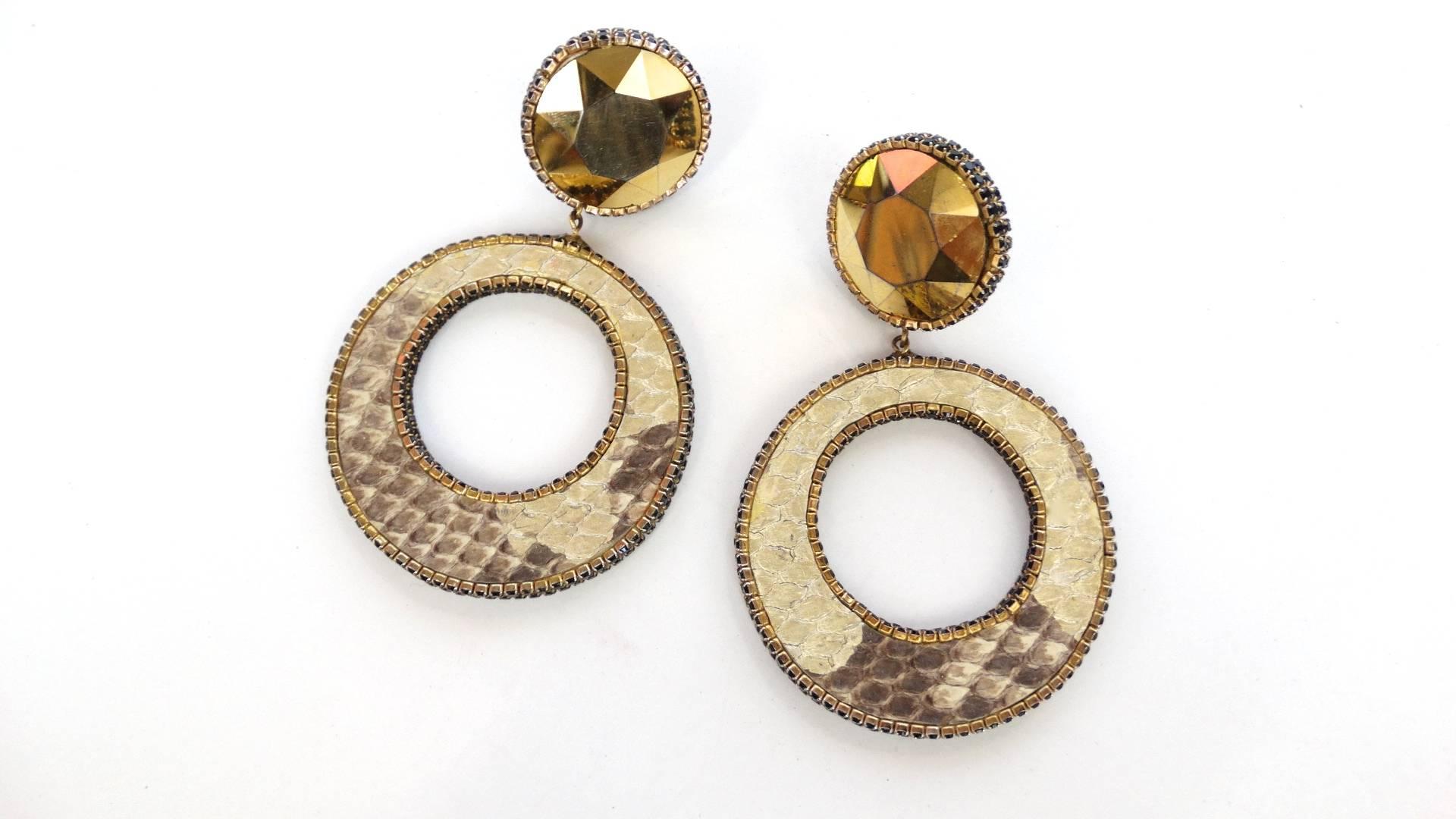 A fabulous pair of Deanna Hamro python hoop earrings. look at the details the edges are trimmed with small black rhinestones adding a great finished look. These earrings are 4 inches long by 2 inches wide. Clips are secure signed Deanna Hamro Los
