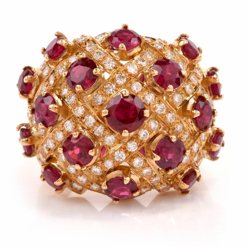 This estate 1980's cocktail ring is crafted in solid18 karat yellow gold, weighing 10.8 grams , and measuring 19mm wide and----mm high. Designed as a vividly colored dome plaque, this cocktail ring exposes 17 variously sized round-faceted 17rubies