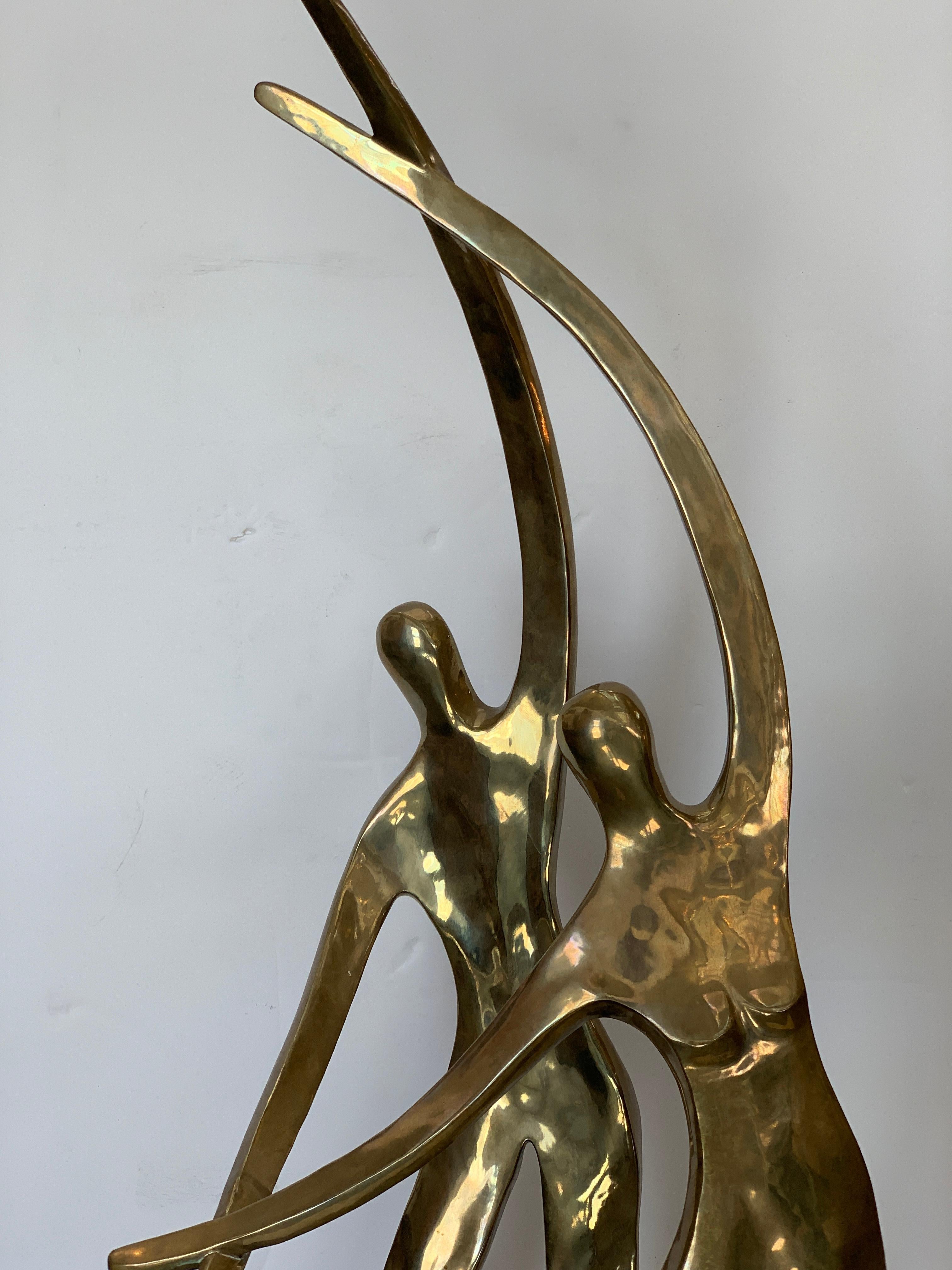A large pretty polished bronze of a dancing couple from 1980 by the noted artist Gardner Locke. It is signed and dated 1980 also marked AP for artist's proof. On a stone or quartz base. There is a corner that has been rounded smooth, detailed in a