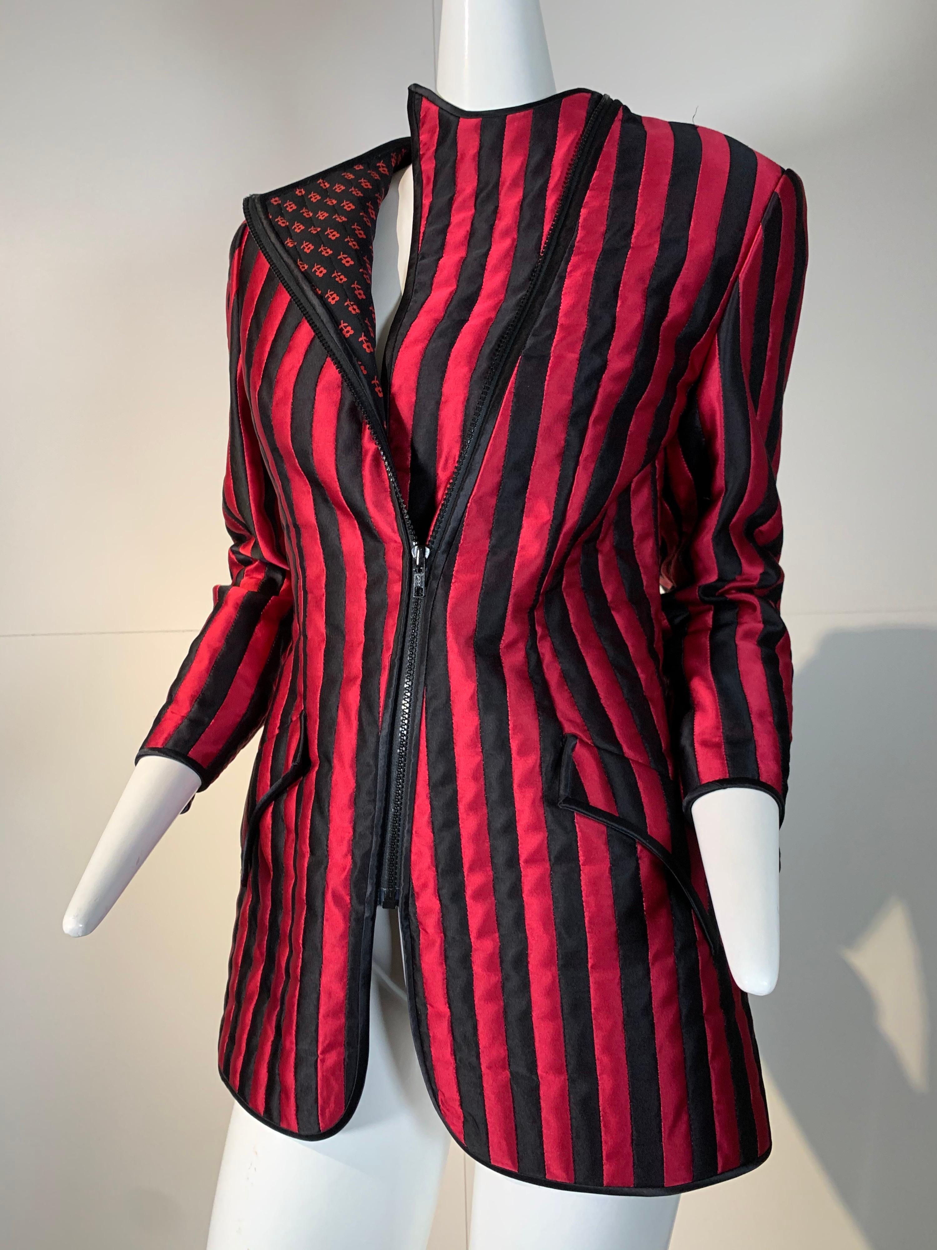 1980s Geoffrey Beene red and black satin pieced stripe smoking-style jacket with asymmetrical zipper:  zipped completely, the collar pieces disappear for a clean sleek look. When half-way zipped, the placket pieces fold back to form floral print