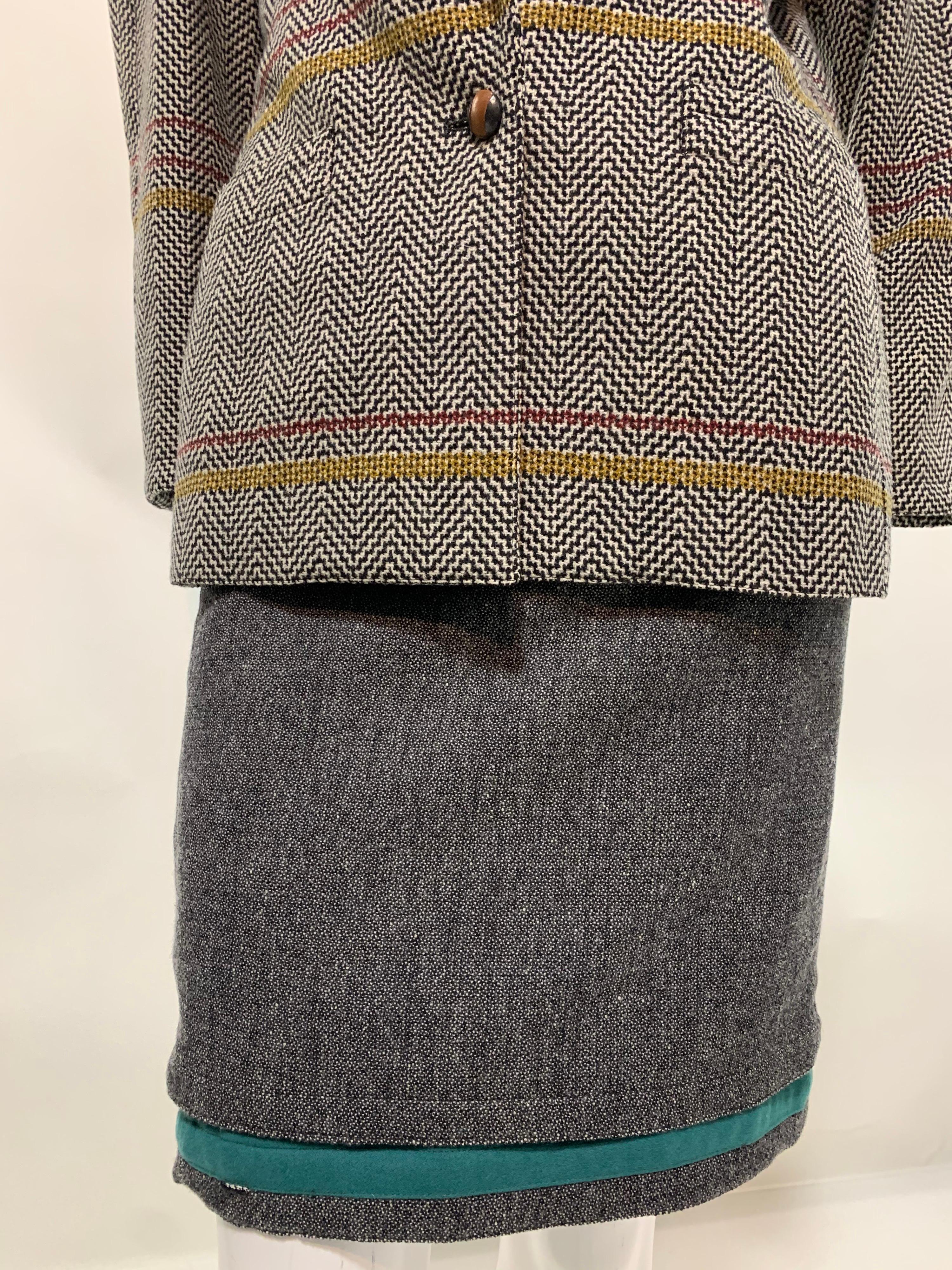 1980s Gianni Versace mixed wool tweed skirt suit with softly structured padded shoulder silhouette. Subtle touches of olive, burgundy and teal. Perfect for a walk in the countryside on a brisk fall day. Jacket is labeled EU 42 and skirt is EU 40.