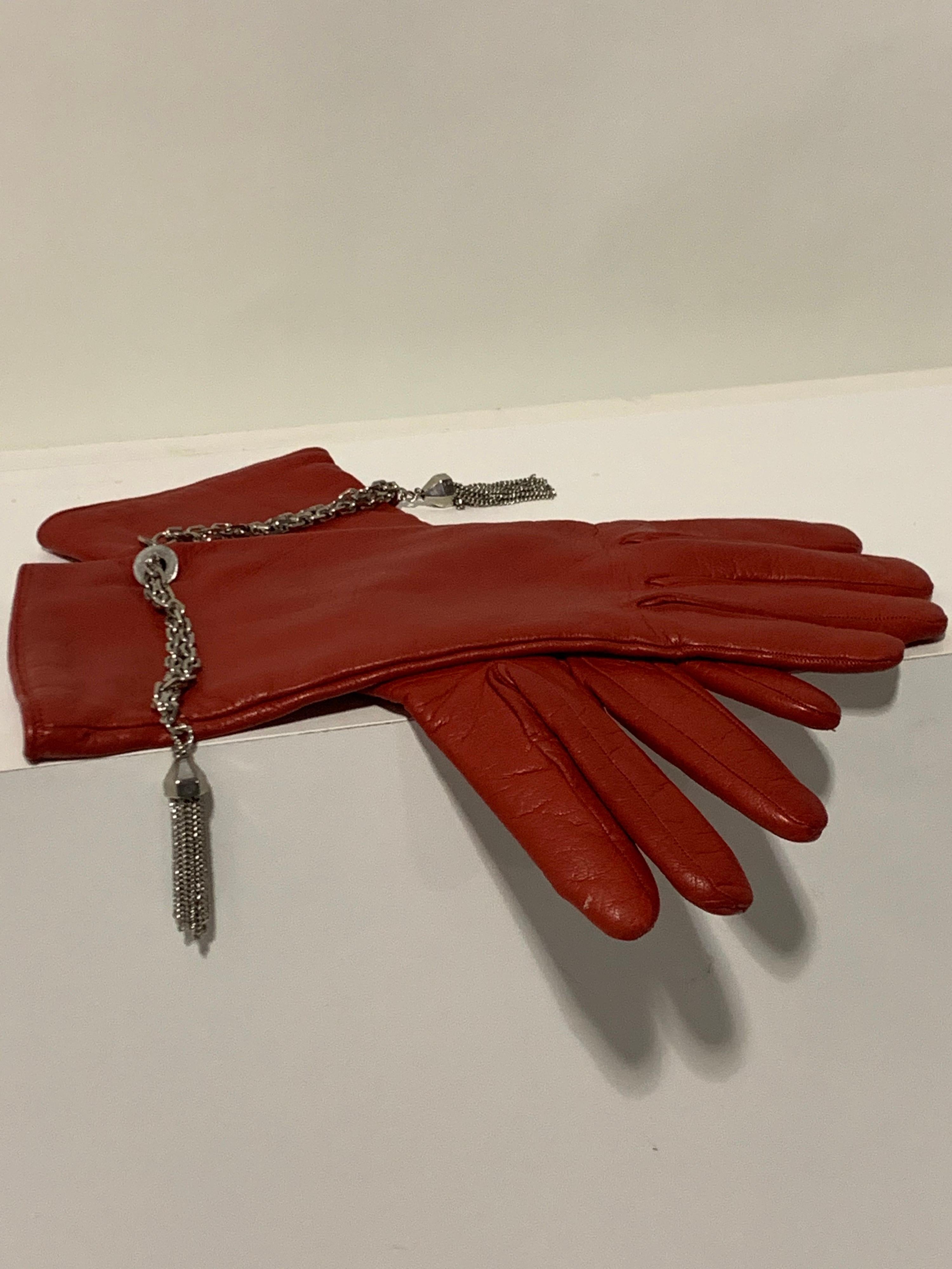 1980s Gianni Versace deep crimson red lambskin leather gloves, lined in cashmere knit with chrome chain and tassel detail at wrists. Size 8. New, never worn. 