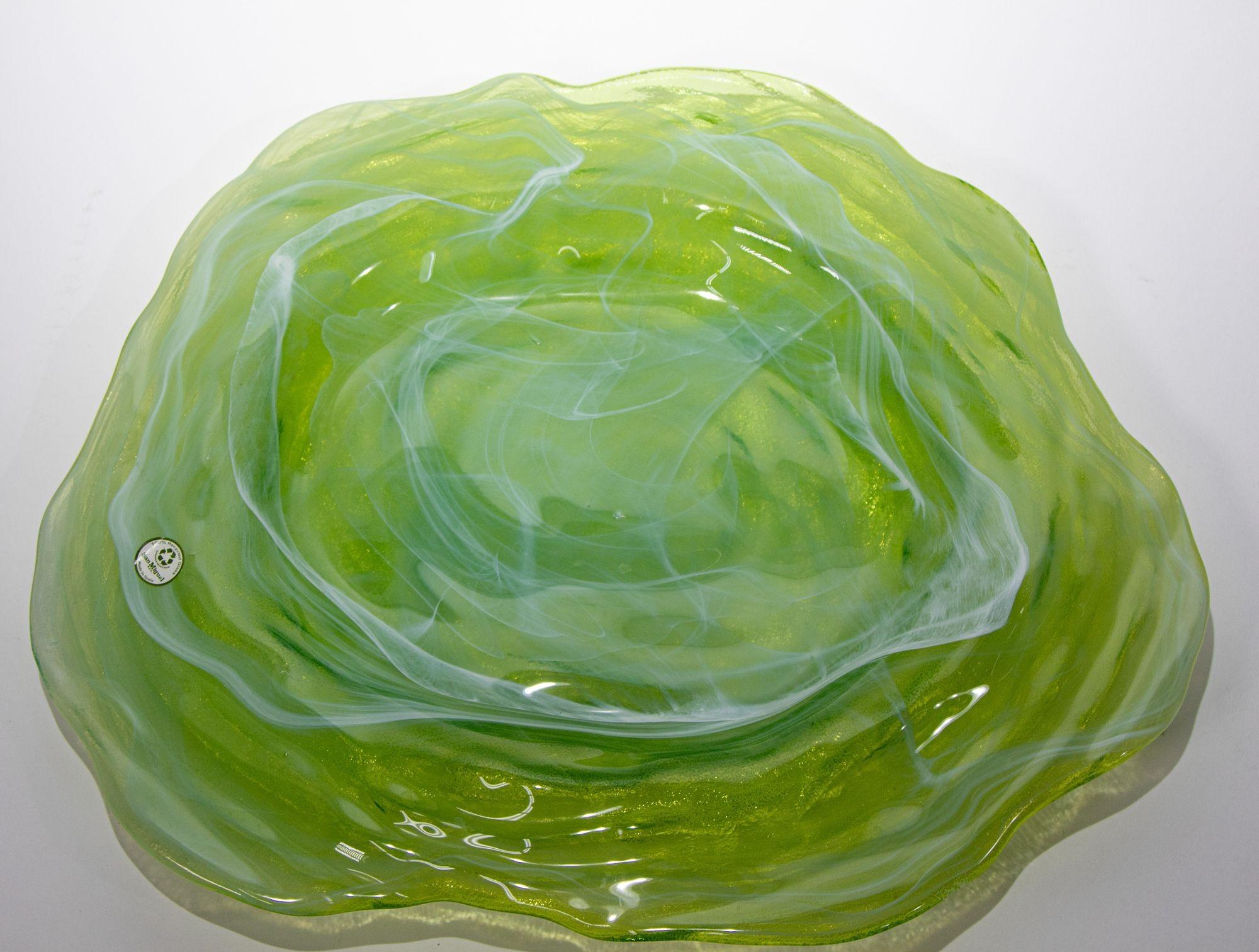 Beautiful green Art glass platter made in Spain.
Green and white swirly glass art bowl hand crafted from recycled glass, round shape free form, great variation in colors and multi dimensional .
The glass is sourced from glass containers which are