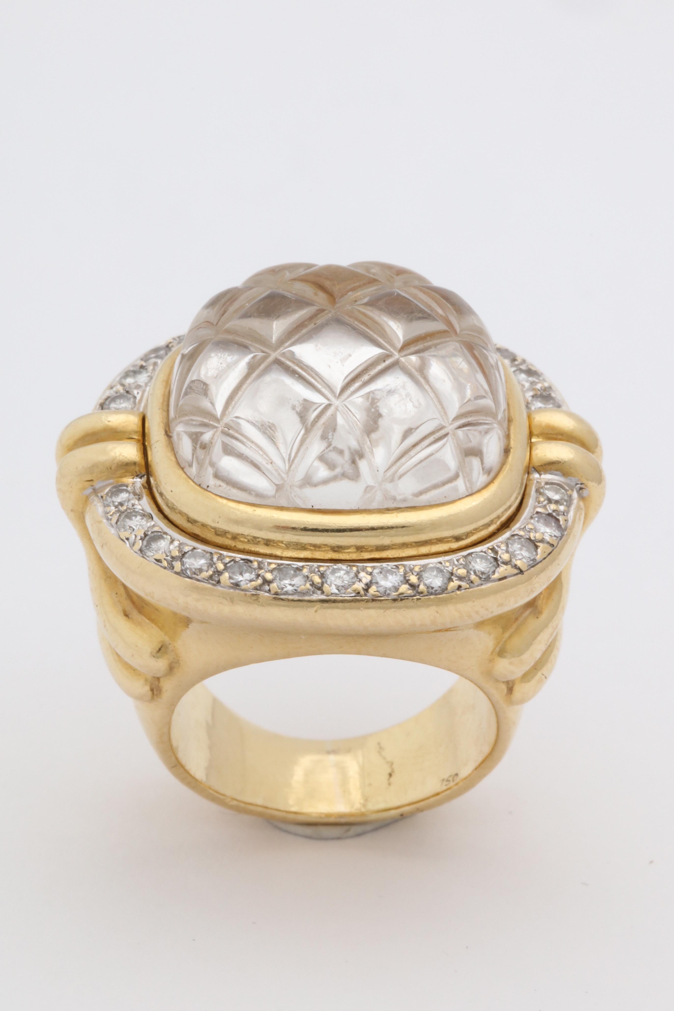 One Large 18kt Yellow Gold High Quality Chic Cocktail Ring Designed With One 18mm Quilted Clear Rock Crystal Stone.This Ultra Chic Ring Is Further Surrounded By Numerous High Quality Full Cut Diamonds Weighing Approximately One Carat Total Weight.