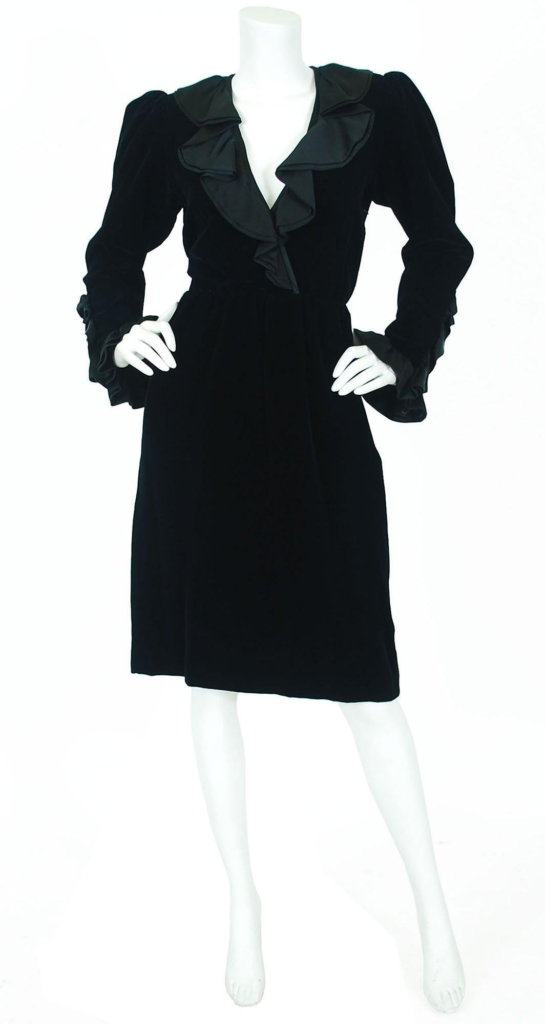 Yves Saint Laurent YSL black velvet dress featuring double layered silk satin ruffles around the faux-wrap style deep v neckline, and around the cuffs, shoulder pads inside uphold the puffed sleeves, a side metal zipper enclosure. 
See attached: