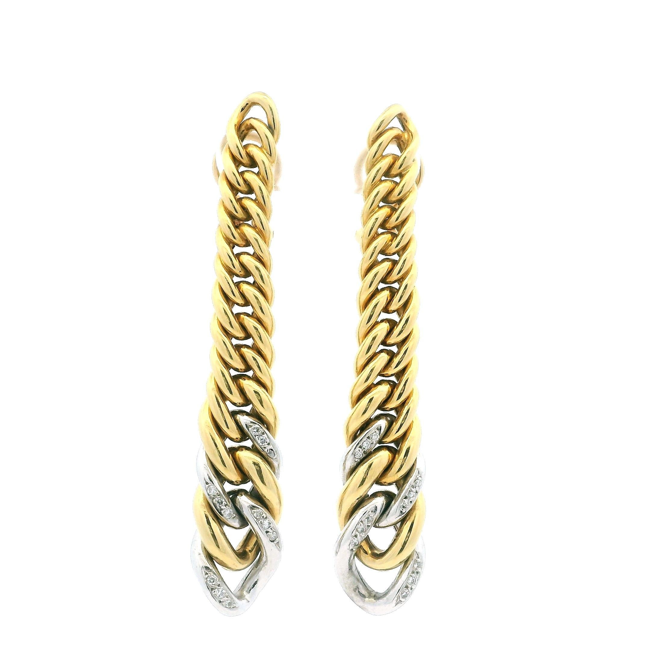 Esempio di glamour italiano anni '80, questi audaci orecchini a cerchio allungati sono realizzati in oro giallo 18 carati e misurano ben 2,5 pollici di lunghezza. L'elegante design intrecciato è accentuato da 24 diamanti rotondi con taglio a
