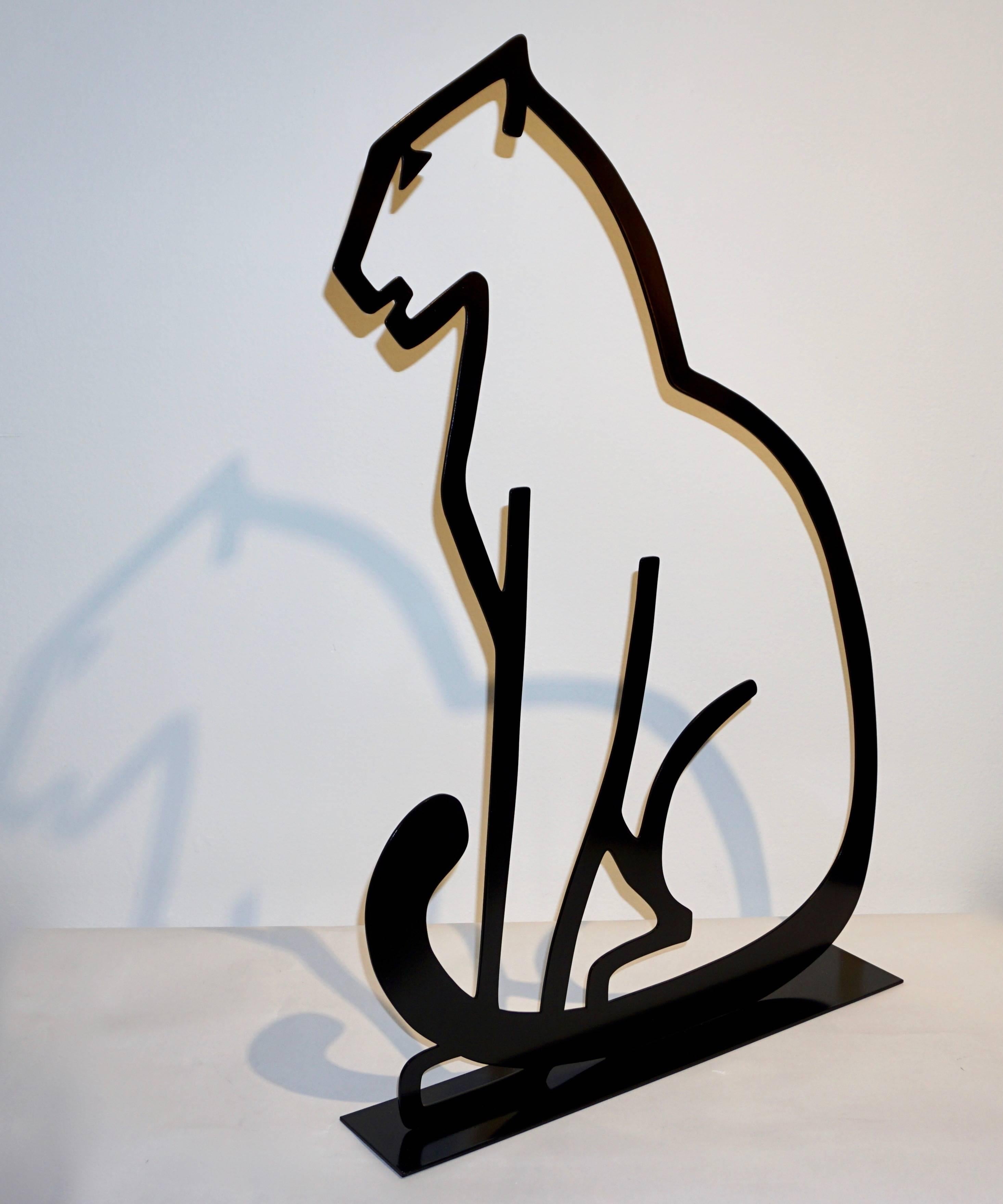 A chic decorative tall metal cut sculpture of organic modern design, depicting a Minimalist panther silhouette, in black lacquered iron, supported by a geometric base. The fine open design creates playful shadows that add depth to this decorative