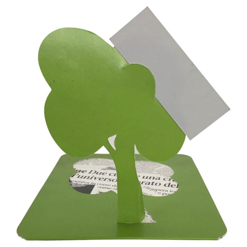 This little and nice sculpture is a cardholder. Cardboard and newspaper print are the materials.
The recycled paper of the newspaper represents one of the first times when the word 