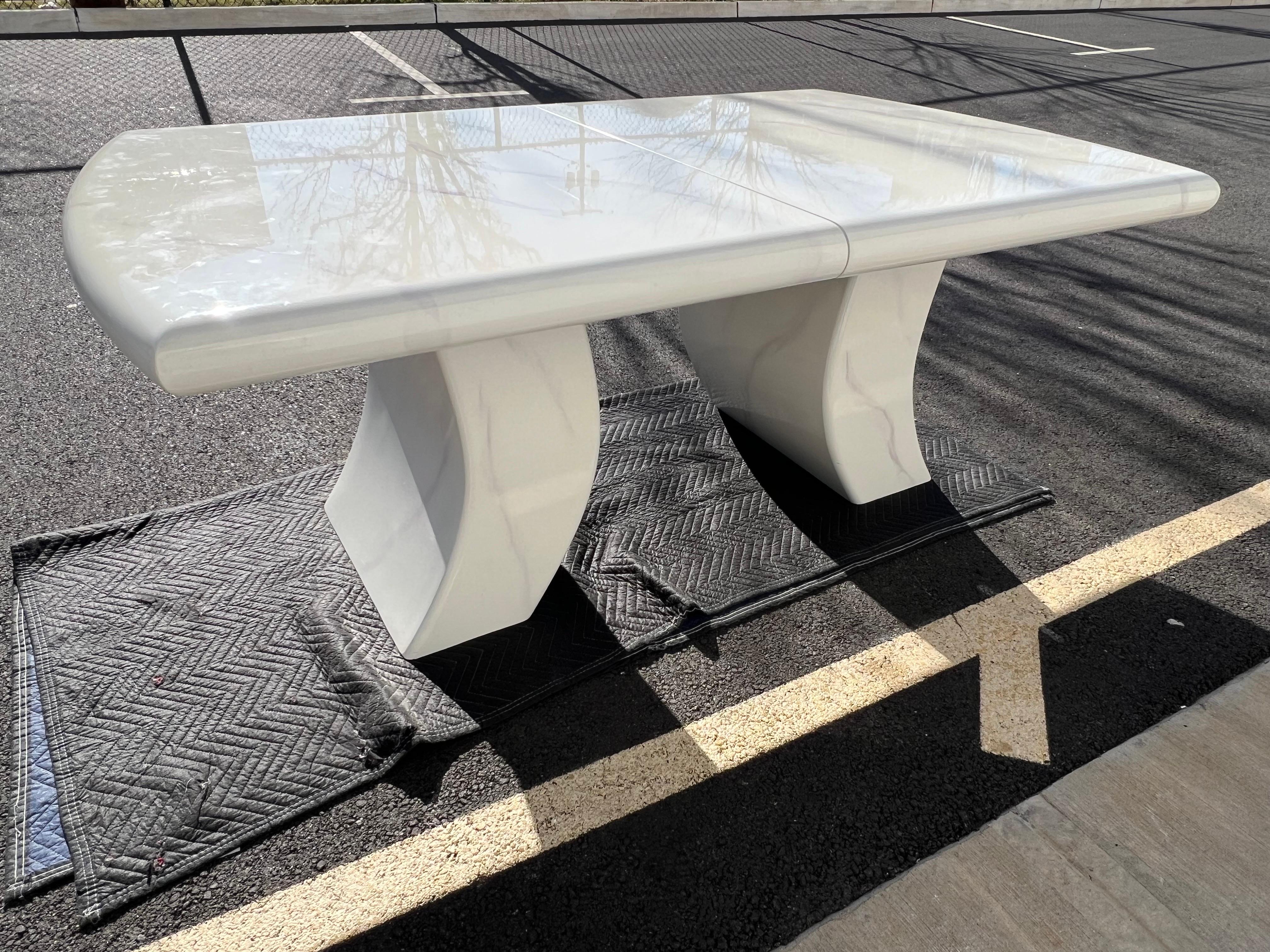Faux purple marble white lacquer dining table in the style of Karl Springer.

Come with two curvy pedestals for the dining table legs. No major defects. Minor dents or scratches, please check all of the photos for the condition.