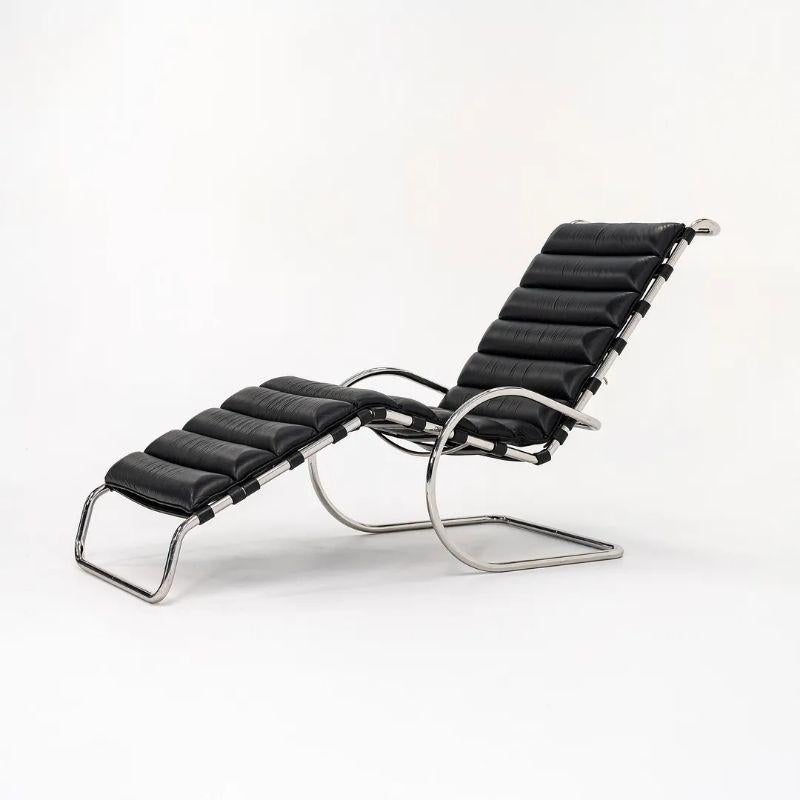 This is a Model 242 MR adjustable Chaise Lounge, originally designed by Ludwig Mies van der Rohe in 1927. This particular example was produced in 1980 by Knoll International in the USA. The chaise features a thick black leather channel-upholstered