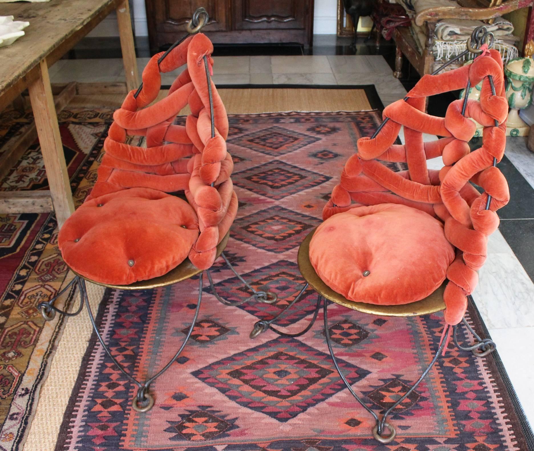 Pair of 1980s French wrought iron chairs with gilded decorations and the original red braided upholstered back.

 