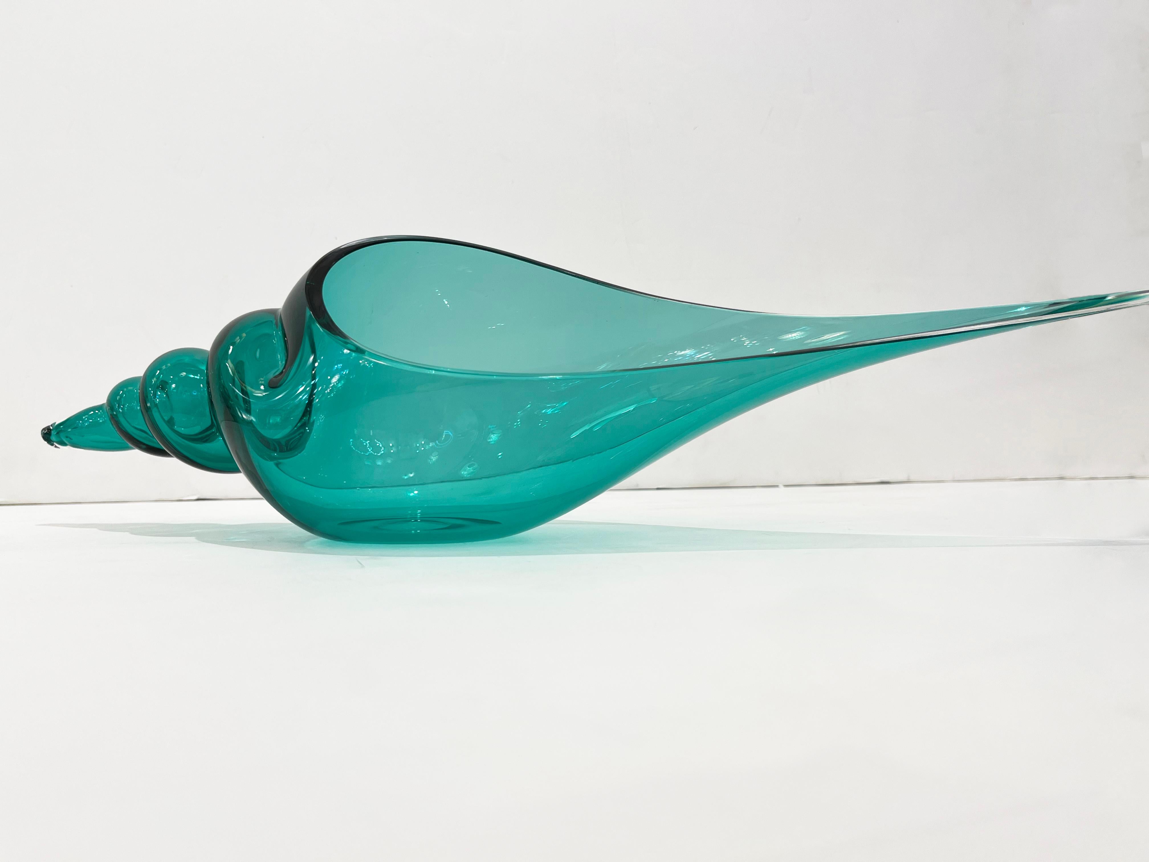 Bring the ocean indoors! This spire coiled shell in a transparent Art Murano Glass with an amazing teal aquamarine blue tint has been freely blown and hand crafted, with extraordinary skill, by Romano Donà on the Murano Island in the Bisazza