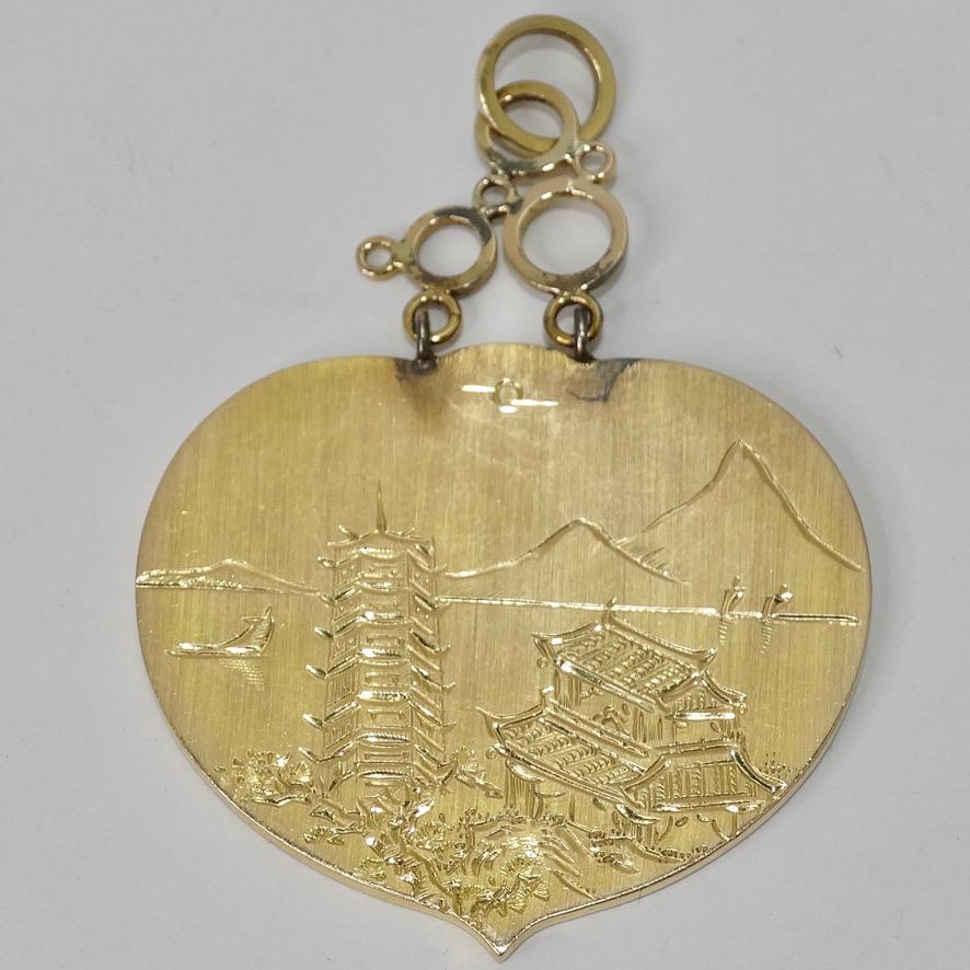 Gorgeous 14K gold heart pendent circa 1980s! Featuring a beautiful jade stone in the center and Japanese style engravings. The back is engraved with the most detailed and beautiful Japanese landscape. This pendent is so intricate and unique, you are