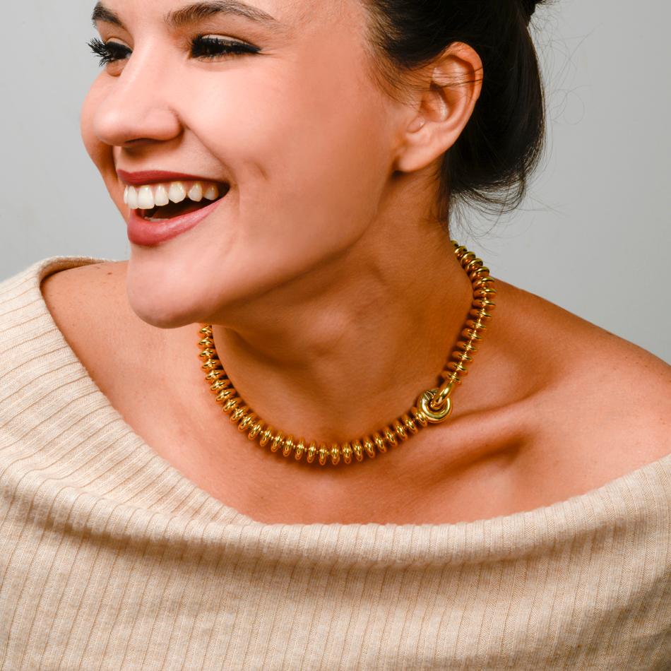 This modern and stylish choker necklace is crafted in solid 18-karat yellow gold, weighing 73.8 grams, measuring 17 inches long and 17mm x 11.5mm wide. Composed of 72 round flat bead and two round clasp that secure by sliding into each other.