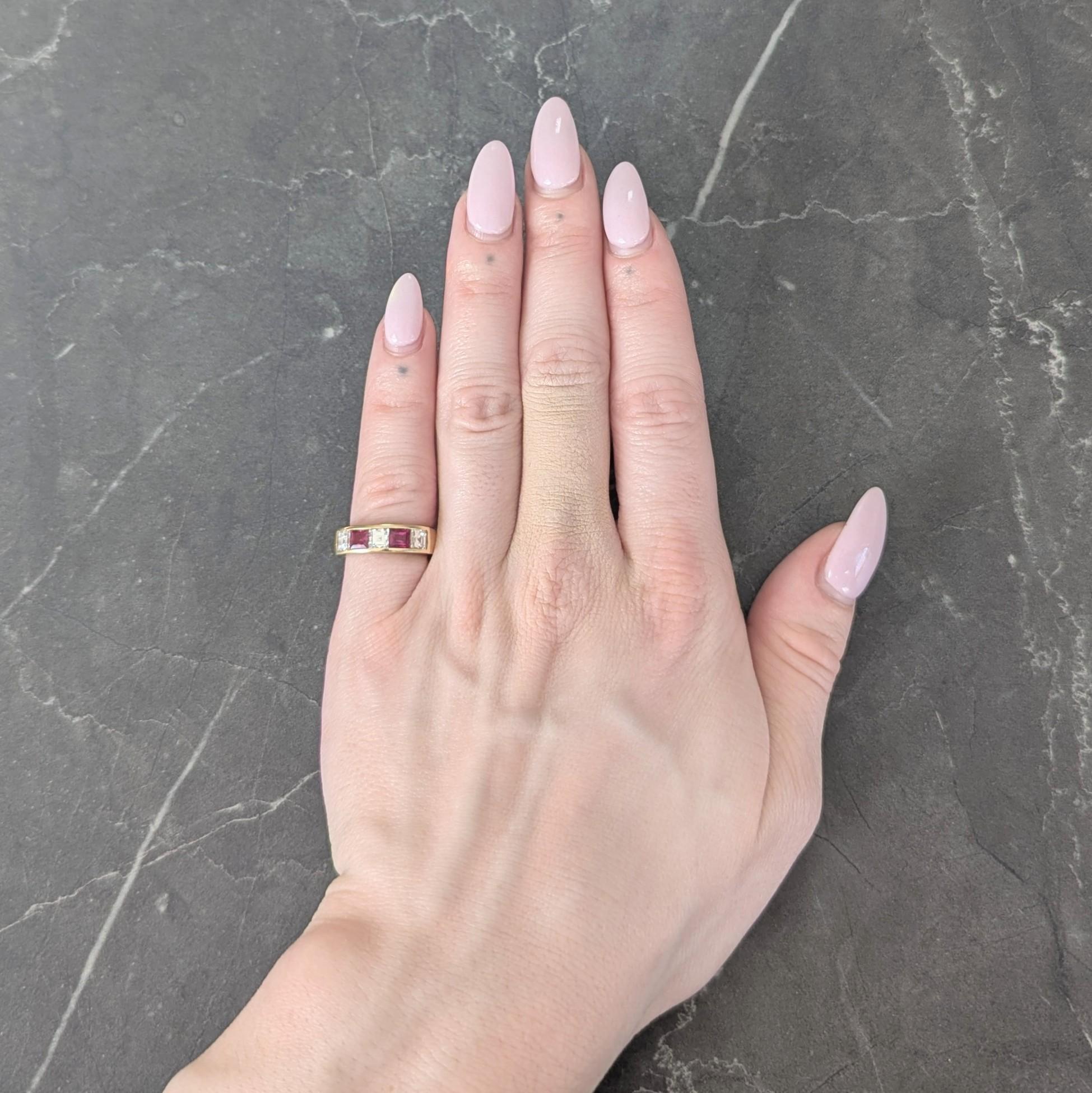 Band ring is channel set to front with square step-cut diamonds and rubies
Diamonds weight approximately 1.00 carat total - G color with VS2 clarity
Rubies weigh approximately 0.80 carat total - transparent medium red
Completed by notched