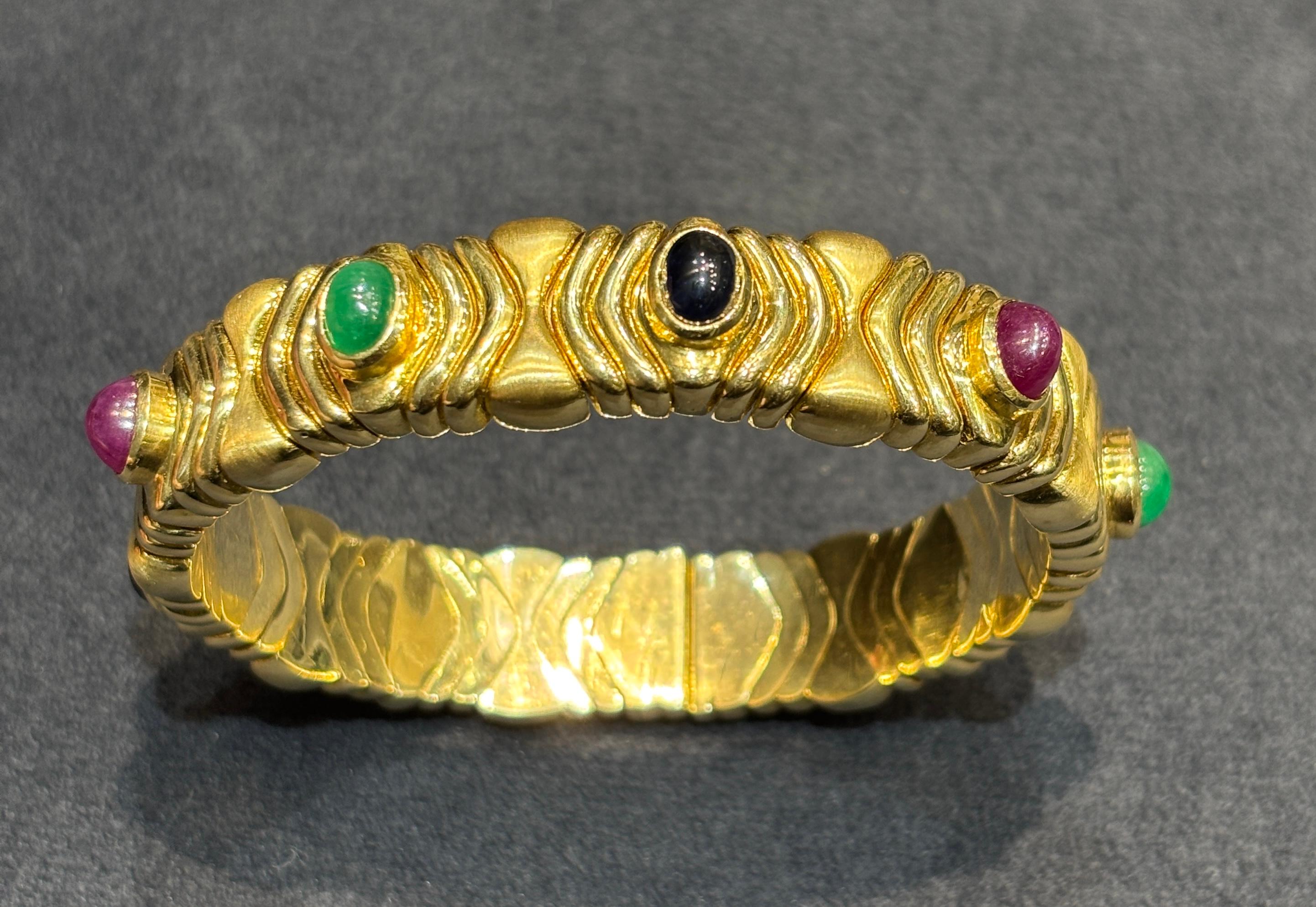 Women's or Men's 1980s 18k gold Bulgari bangle with ruby, sapphire and emerald For Sale
