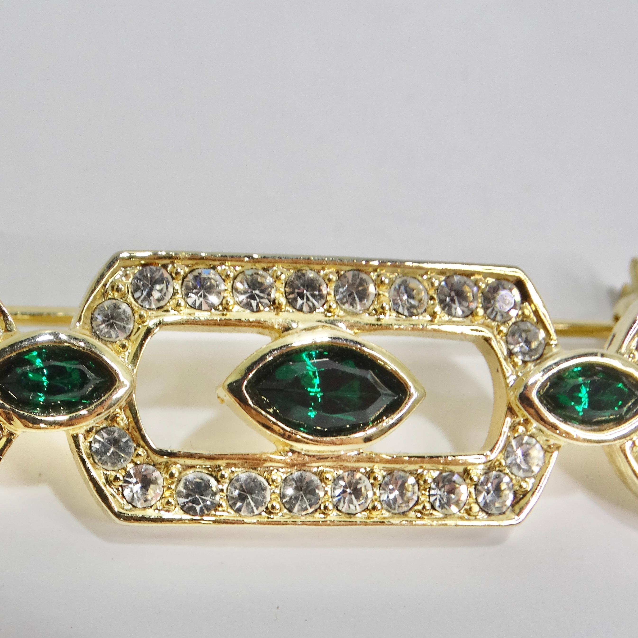 Step back into the glamorous world of the 1980s with our exquisite 18K Gold Plated Synthetic Emerald Brooch. This vintage-inspired masterpiece features a captivating arrangement of vibrant synthetic emeralds that evoke the elegance of a bygone era.