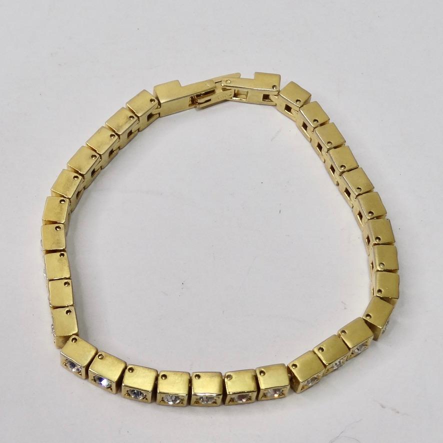 This 1980s gold tone tennis bracelet is going to become your next go-to every day accessory! Beautiful 18K plated gold alongside clear rhinestones come together to create this classic and timeless bracelet! You can never have enough tennis
